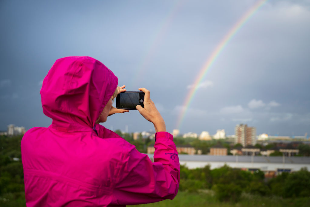 A woman photographs a rainbow over Cardiff City centre on May 27, 2019 in Cardiff, United Kingdom. (Matthew Horwood&mdash;Getty Images)