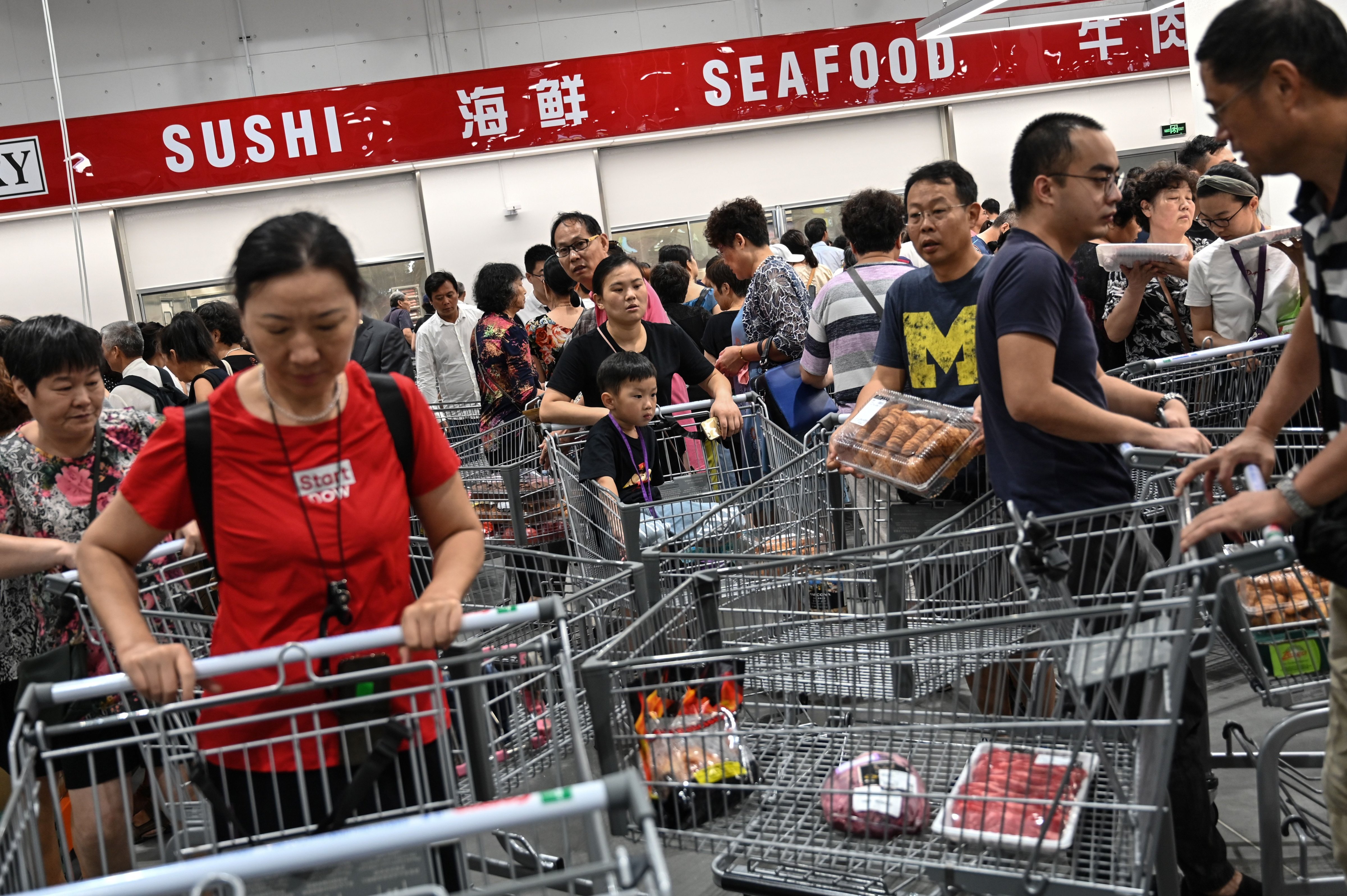 People visit the first Costco outlet in China, on the stores opening day in Shanghai on August 27, 2019. - (HECTOR RETAMAL—AFP/Getty Images)