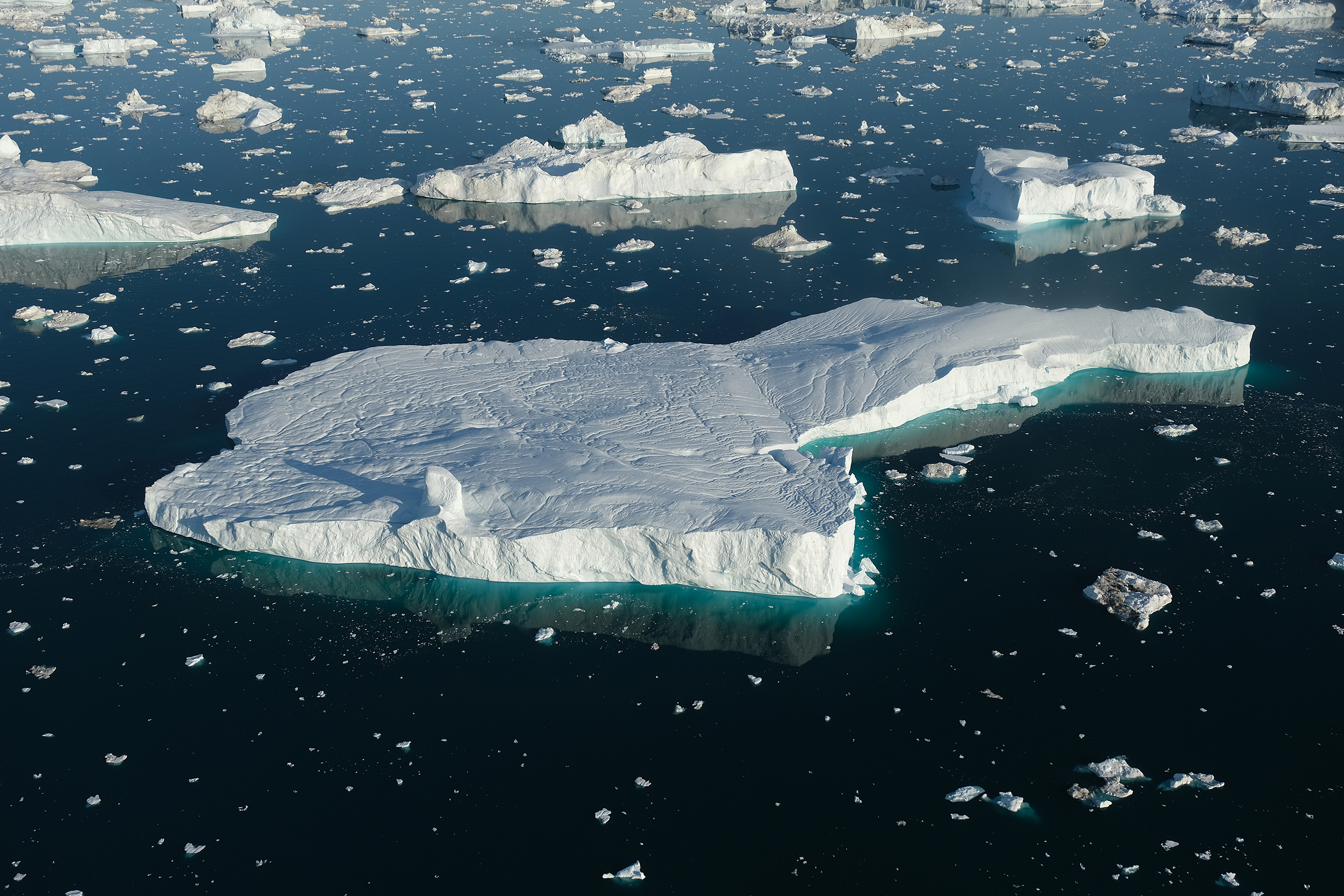In this view from an airplane icebergs float in Disko Bay on August 4, 2019 near Ilulissat, Greenland. (Sean Gallup—Getty Images)