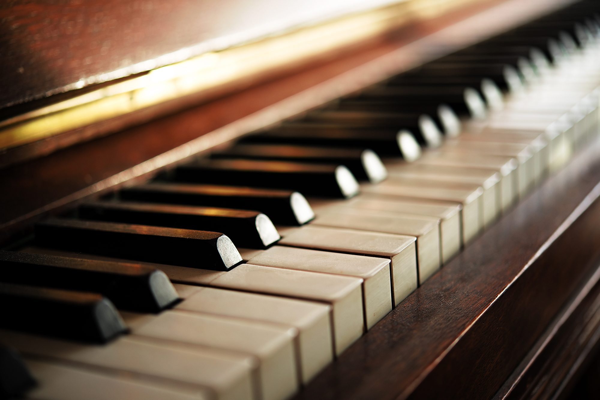 Piano keyboard of an old music instrument, close up