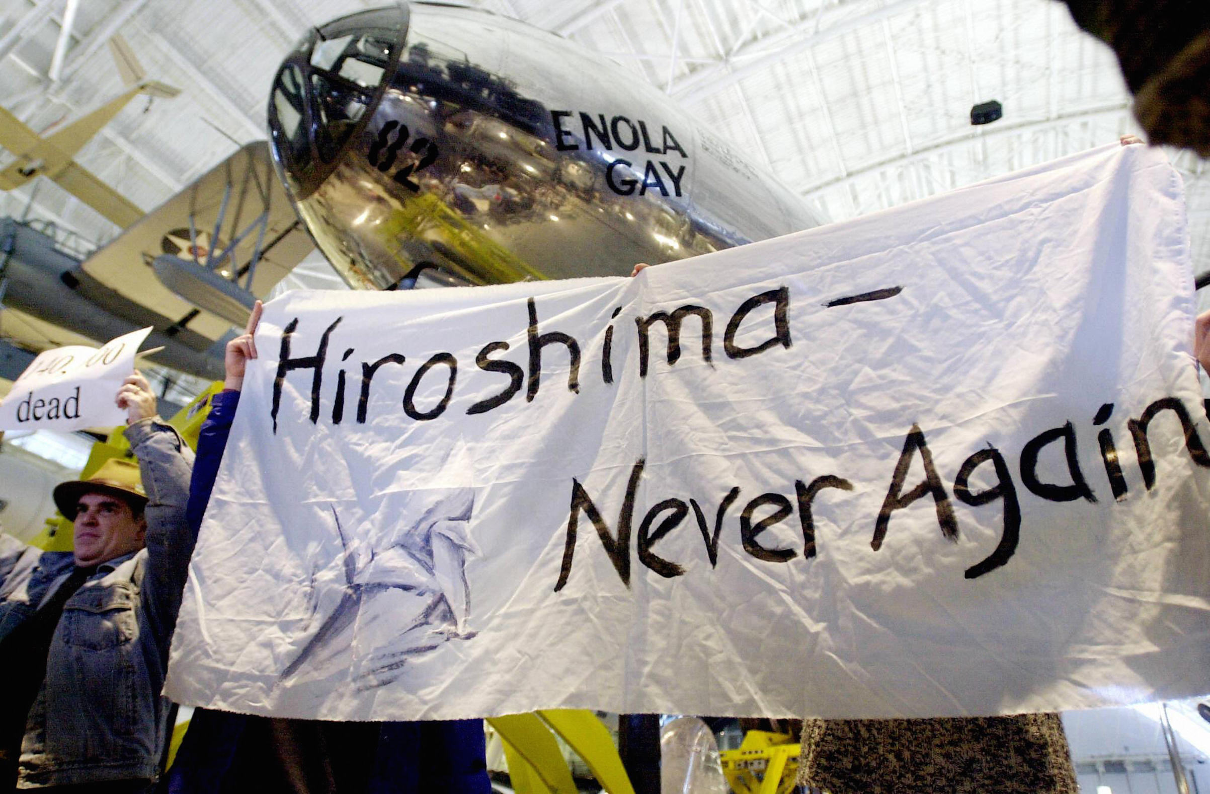 Demonstrators protest at the Enola Gay exhibit at the the Smithsonian National Air and Space Museum's Steven F. Udvar-Hazy Center , on its opening day, Dec. 15, 2003 in Chantilly, Va. (Joyce Naltchayan—AFP/Getty Images)