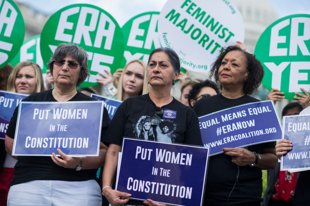 Jessica Lenahan, center, a domestic violence survivor, and Carol Jenkins, right, of the Equal Rights Amendment Task Force, attend a news conference at the House Triangle on the need to ratify the Equal Rights Amendment on June 6, 2018. (Tom Williams&mdash;CQ-Roll Call,Inc.)
