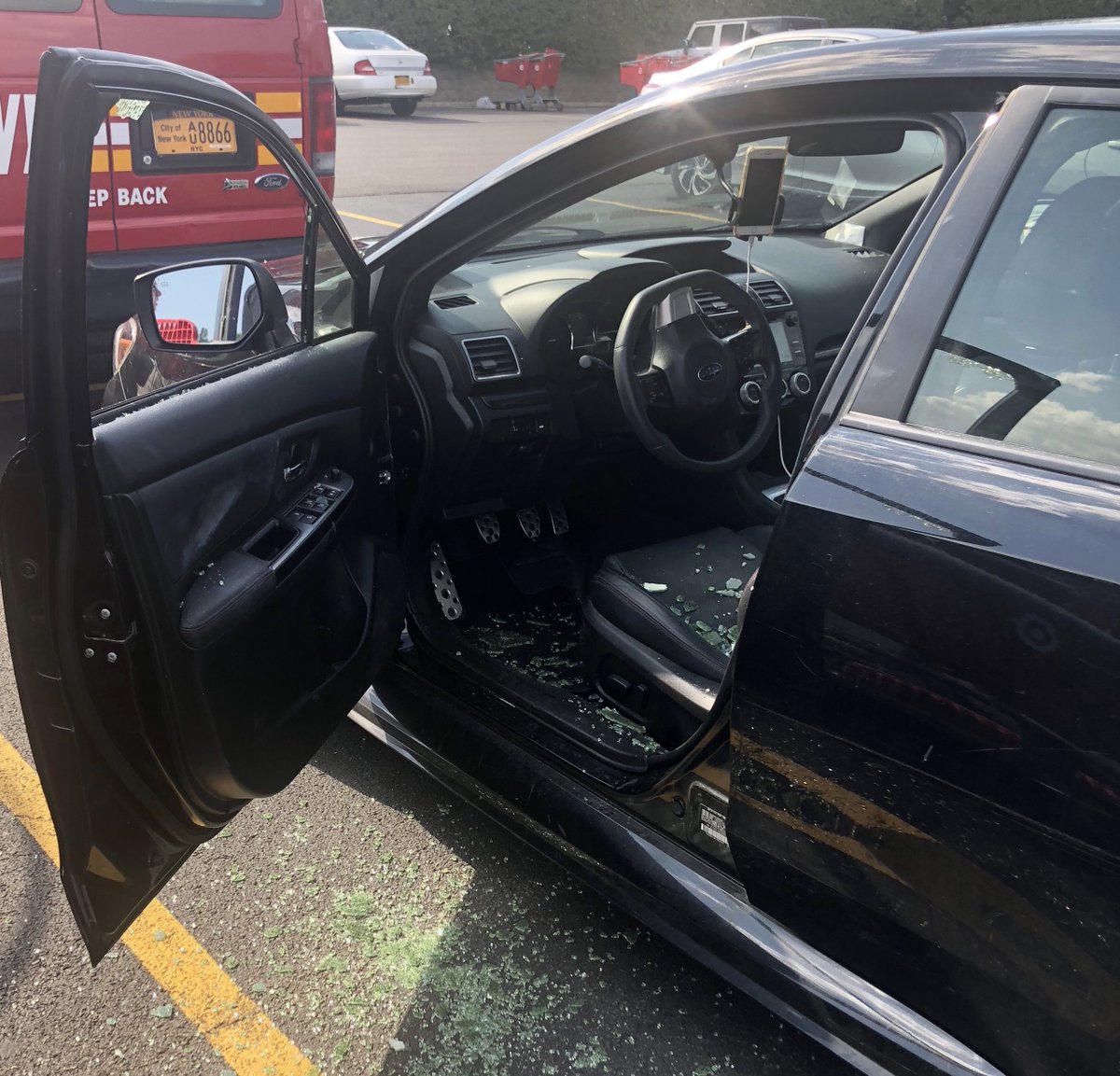 A car window in Queens, New York on Thursday, Aug. 8, 2019 broken in an effort to save a four-year-old boy from the overheating vehicle. (Courtesy of FDNY via Twitter)
