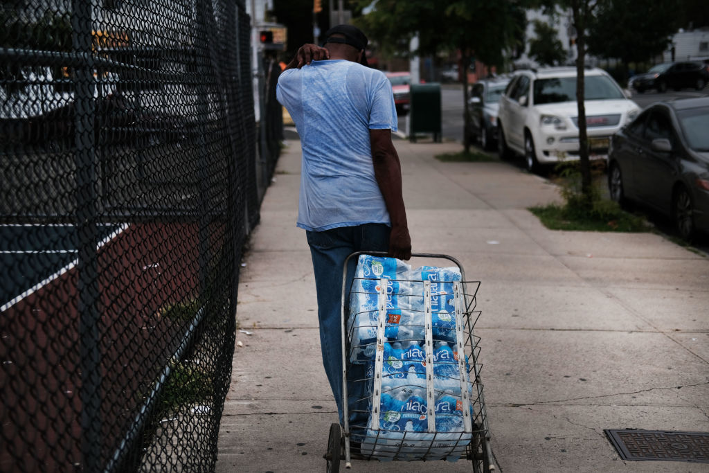 People wait in line for bottled water at a recreation center on August 13, 2019 in Newark, New Jersey. Residents of Newark, the largest city in New Jersey, are to receive free water after lead was found in the tap water. (Spencer Platt—Getty Images)