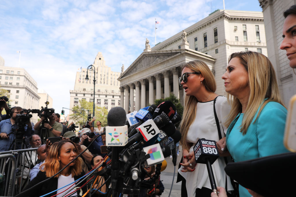 Jennifer Araoz, 32, who alleges that Jeffrey Epstein raped her in his New York townhouse in 2002 when she was only 14, speaks to the media with her lawyer after leaving the New York court house on August 27, 2019. (Spencer Platt—Getty Images)
