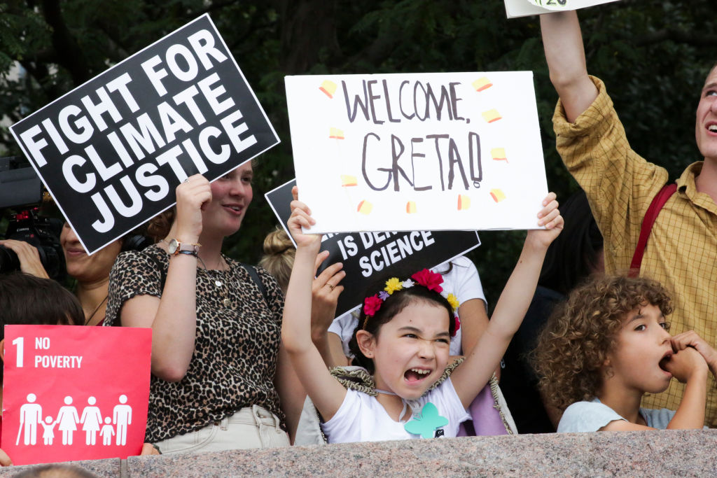 People welcome climate activist Greta Thunberg to New York as she arrives in the US after a 15-day journey crossing the Atlantic in the Malizia II, a zero-carbon yacht, on Aug. 28, 2019. (KENA BETANCUR—AFP/Getty Images)