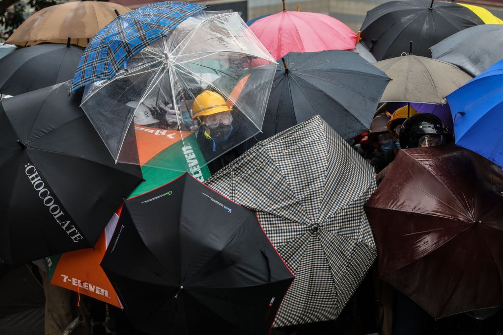 Protesters shield themselves with umbrellas against pepper spray used by the police during a rally in Hong Kong on June 12, 2019. (Dale De La Rey—AFP/Getty Images)