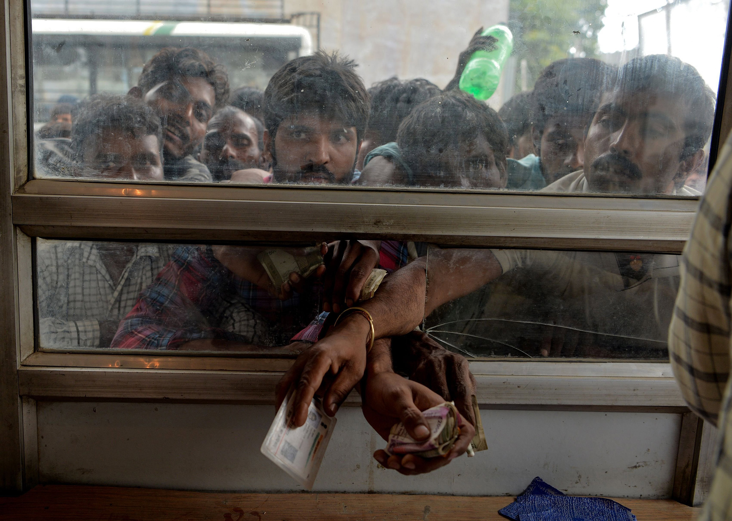 Laborers buy bus tickets at a counter of Jammu and Kashmir Tourist Reception Centre (JKTRC) in Srinagar on Aug. 7 (Sajjad Hussain—AFP/Getty Images)