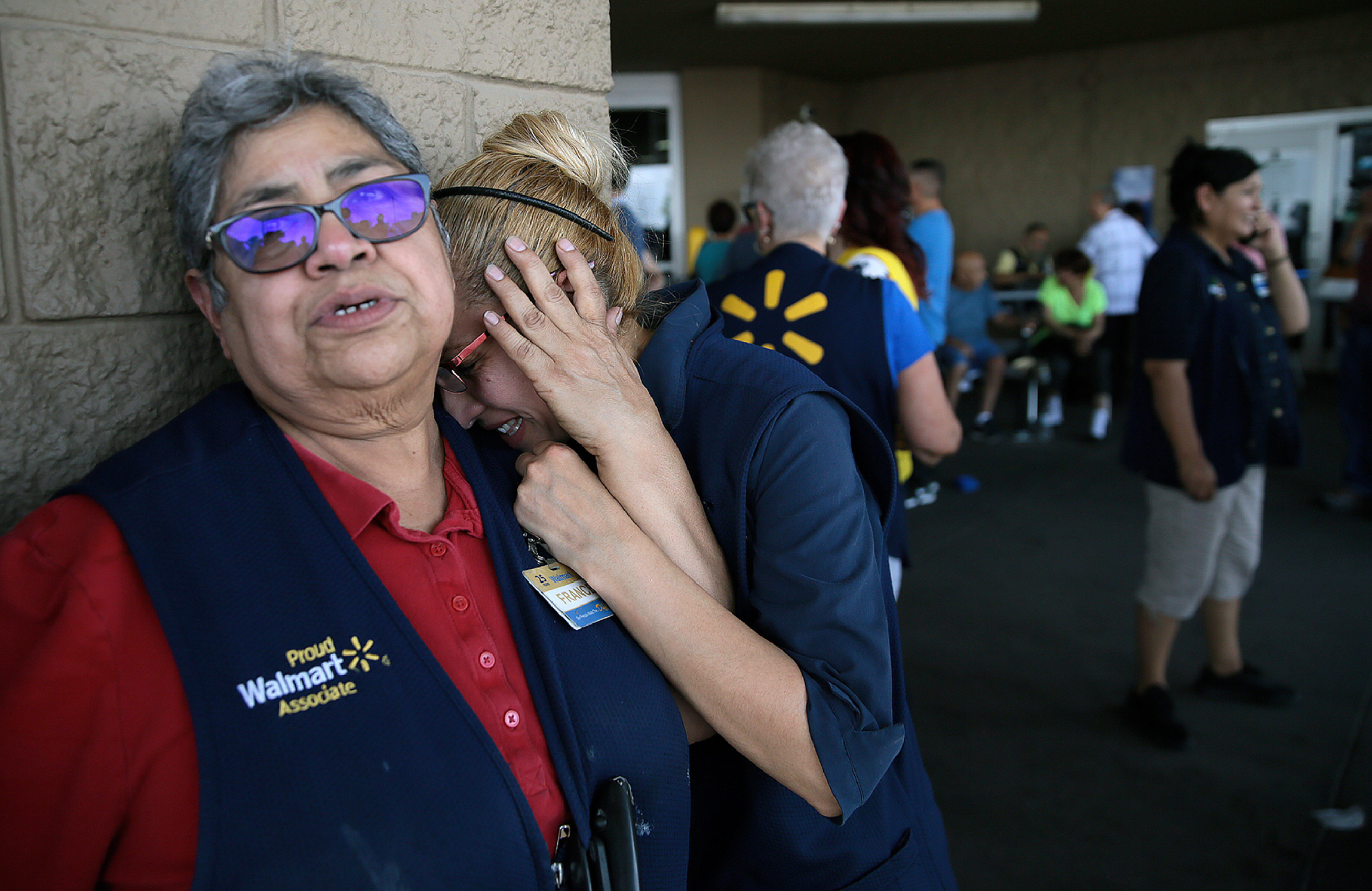 Walmart employees react after an active shooter opened fire at the store in El Paso, Texas, Saturday, Aug. 3, 2019. (Mark Lambie—The El Paso Times/AP)