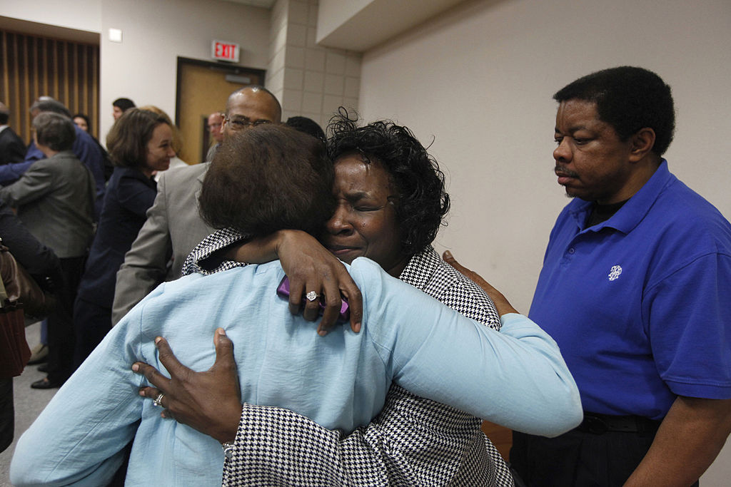 Shirley Burns, center, hugs her friend after a judge found that racial bias played a role in the trial and death row sentencing of Burns' son Marcus Robinson on Friday, April 20, 2012, in Fayetteville, North Carolina. The ruling meant Robinson's sentence was immediately converted to life without possibility for parole. (Shawn Rocco/Raleigh News Observer/MCT—Getty Images)