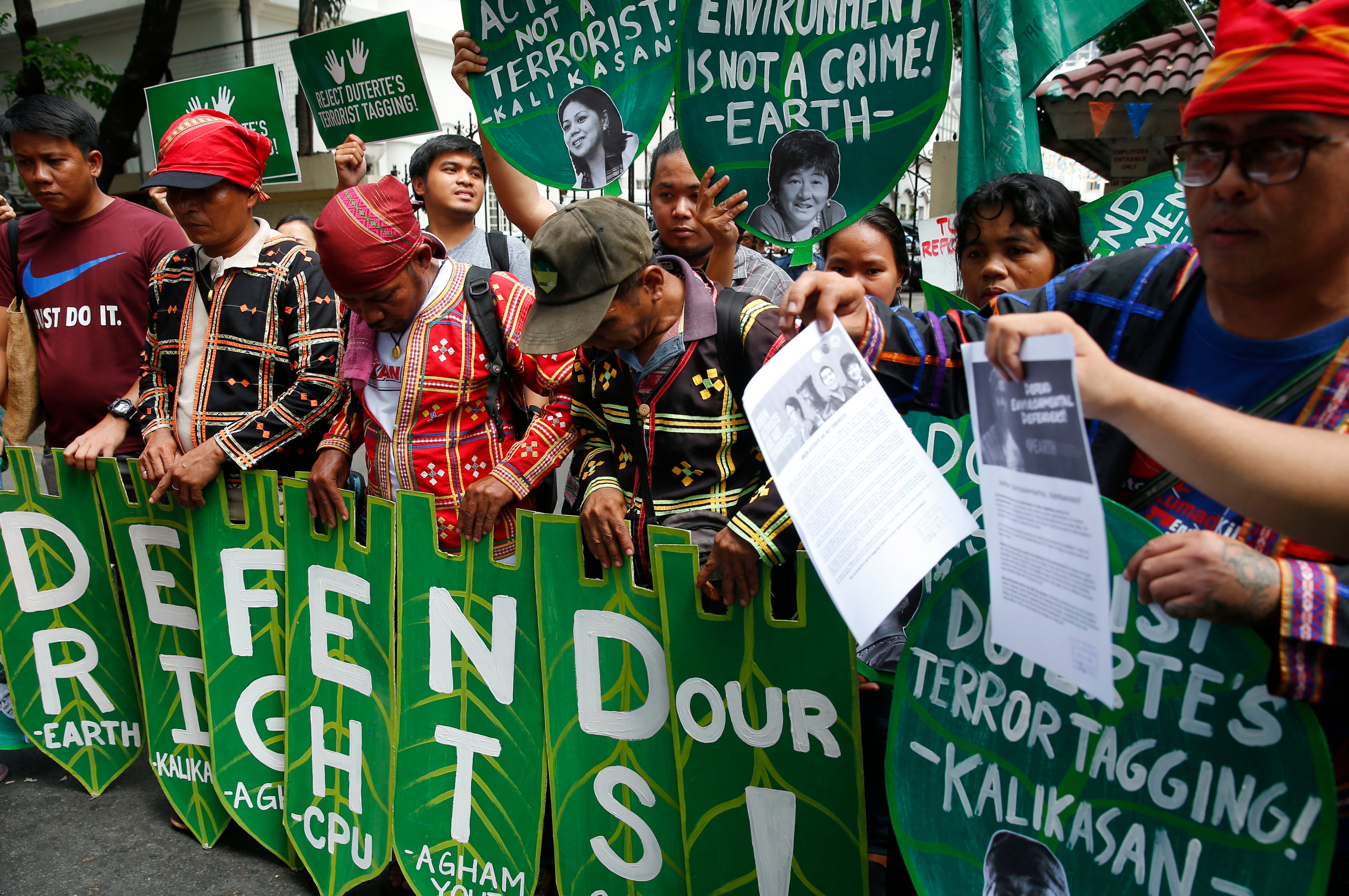 Environmental activists display placards during a rally at the Department of Justice to demand the Philippine government withdraw its alleged list of "terrorists" which includes more than three dozen environmentalists in Manila, Philippines on April 20, 2018. (Bullit Marquez&mdash;AP)