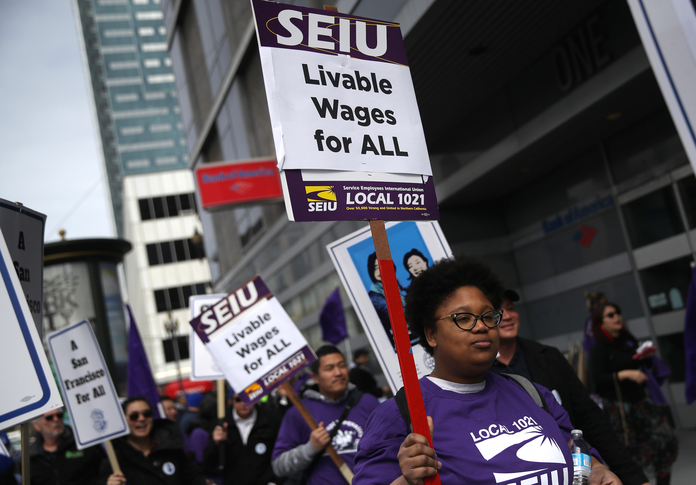 San Francisco city workers carry signs as they march during a rally outside the City and County of San Francisco Human Resources office on March 7, 2019, in San Francisco. Hundreds of San Francisco city workers staged a rally to demand a fair contract that addresses pay equity for women. Public-sector employment is a major factor in the race and gender wage gap. (Justin Sullivan—Getty Images)