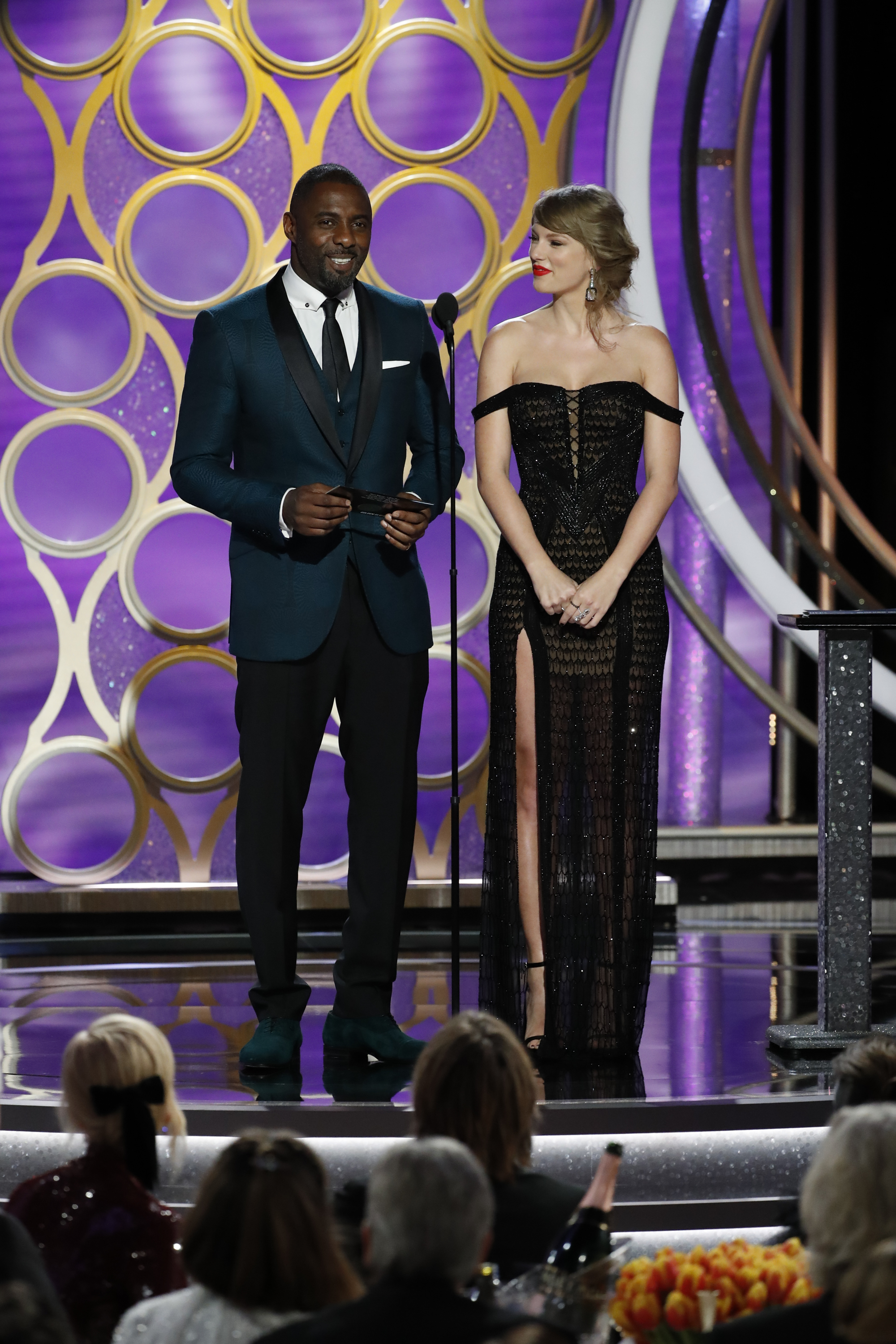 Presenters Taylor Swift and Idris Elba speak onstage during the 76th Annual Golden Globe Awards at The Beverly Hilton Hotel on January 06, 2019 in Beverly Hills, California. (Handout/NBCUniversal—Getty Images)