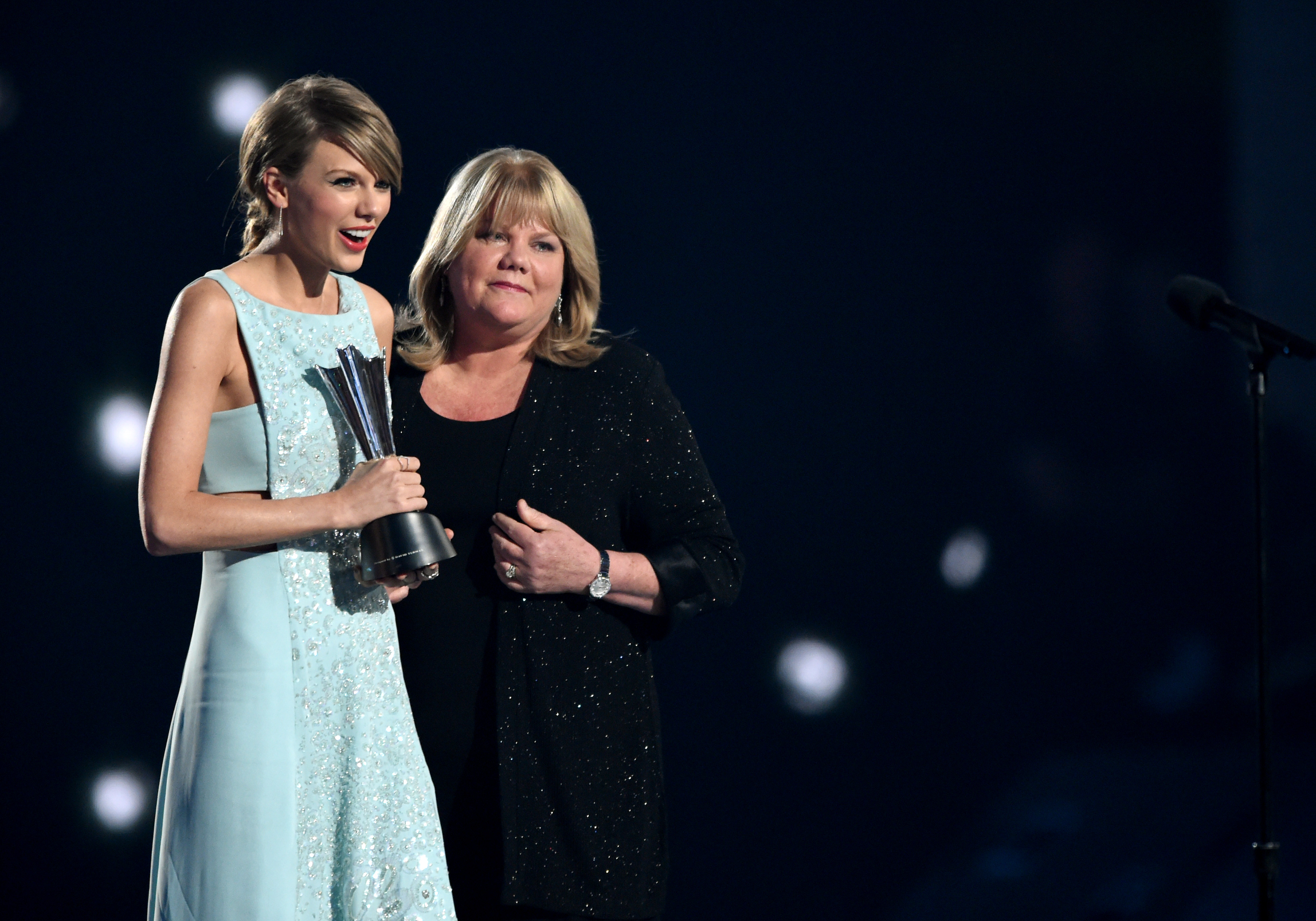 Honoree Taylor Swift accepts the Milestone Award from Andrea Swift onstage during the 50th Academy Of Country Music Awards at AT&T Stadium on April 19, 2015 in Arlington, Texas. (Cooper Neill—Getty Images)
