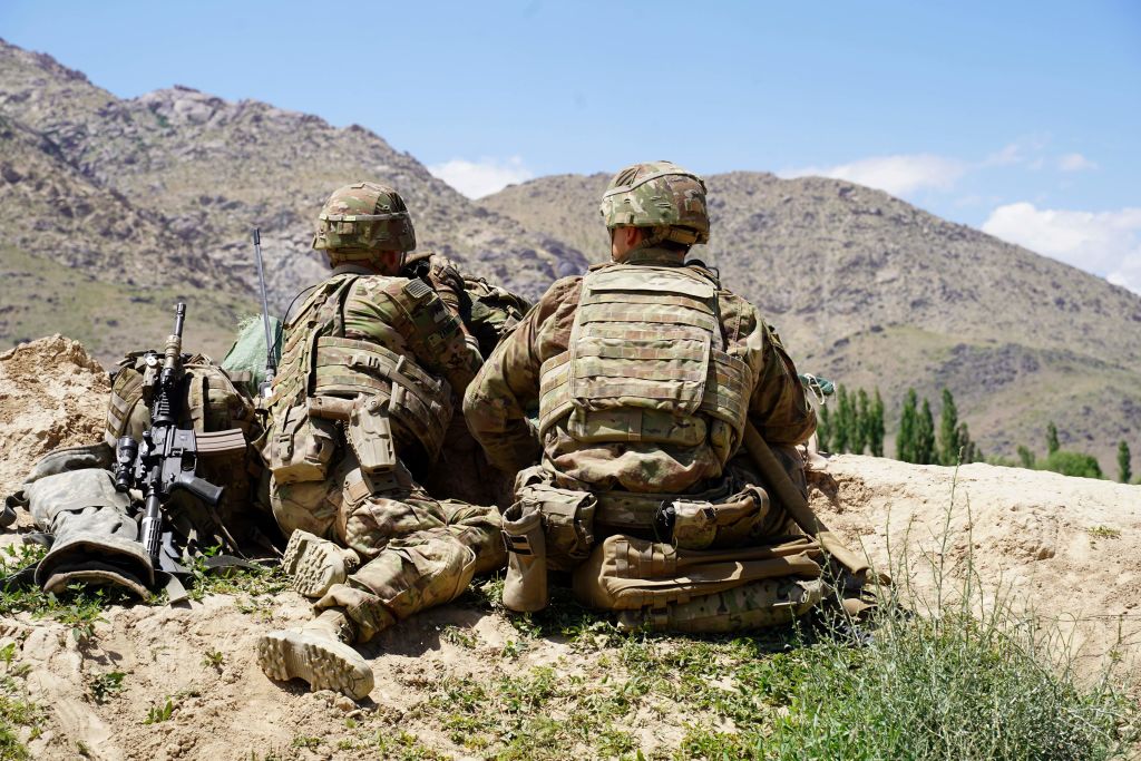 In this photo taken on June 6, 2019, US soldiers look out over hillsides during a visit of the commander of US and NATO forces in Afghanistan General Scott Miller at the Afghan National Army (ANA) checkpoint in Nerkh district of Wardak province. - A skinny tangle of razor wire snakes across the entrance to the Afghan army checkpoint, the only obvious barrier separating the soldiers inside from any Taliban fighters that might be nearby. (Photo by THOMAS WATKINS / AFP) / To go with 'AFGHANISTAN-CONFLICT-MILITARY-US,FOCUS' by Thomas WATKINS        (Photo credit should read THOMAS WATKINS/AFP/Getty Images) (THOMAS WATKINS&mdash;AFP/Getty Images)
