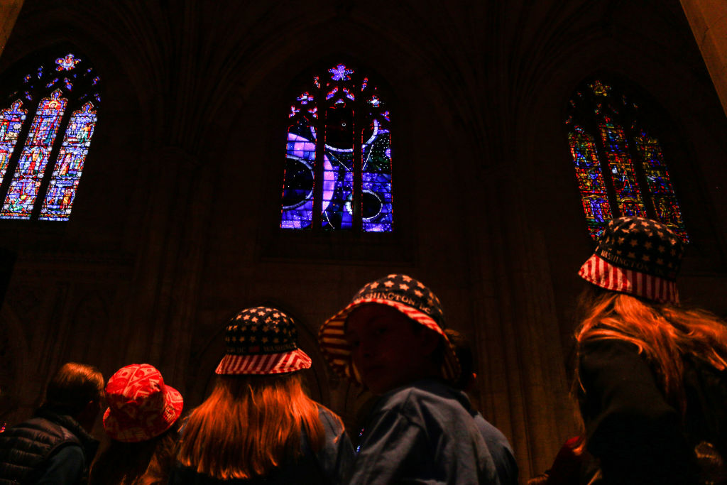 People observe the Washington National Cathedral's "Space Window" on June 11, 2019 in Washington, D.C. (Anna-Rose Gassot—AFP/Getty Images)
