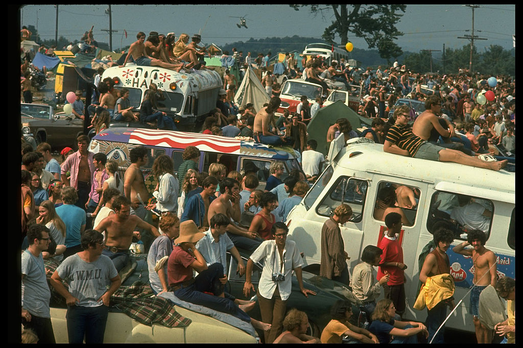 Large crowd of people, including people sitting on top of cars & buses, during the Woodstock Music & Art Fair in August of 1969. (John Dominis—The LIFE Picture Collection via)
