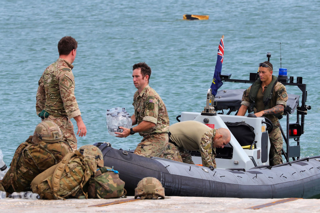 Members of the Humanitarian and Disaster Relief (HADR) team from The Royal Fleet Auxiliary ship Mounts Bay deliver aid to the Islanders of Great Abaco in The Bahamas on September 4, 2019. (AFP Photo / UK MOD / CROWN COPYRIGHT 2019)