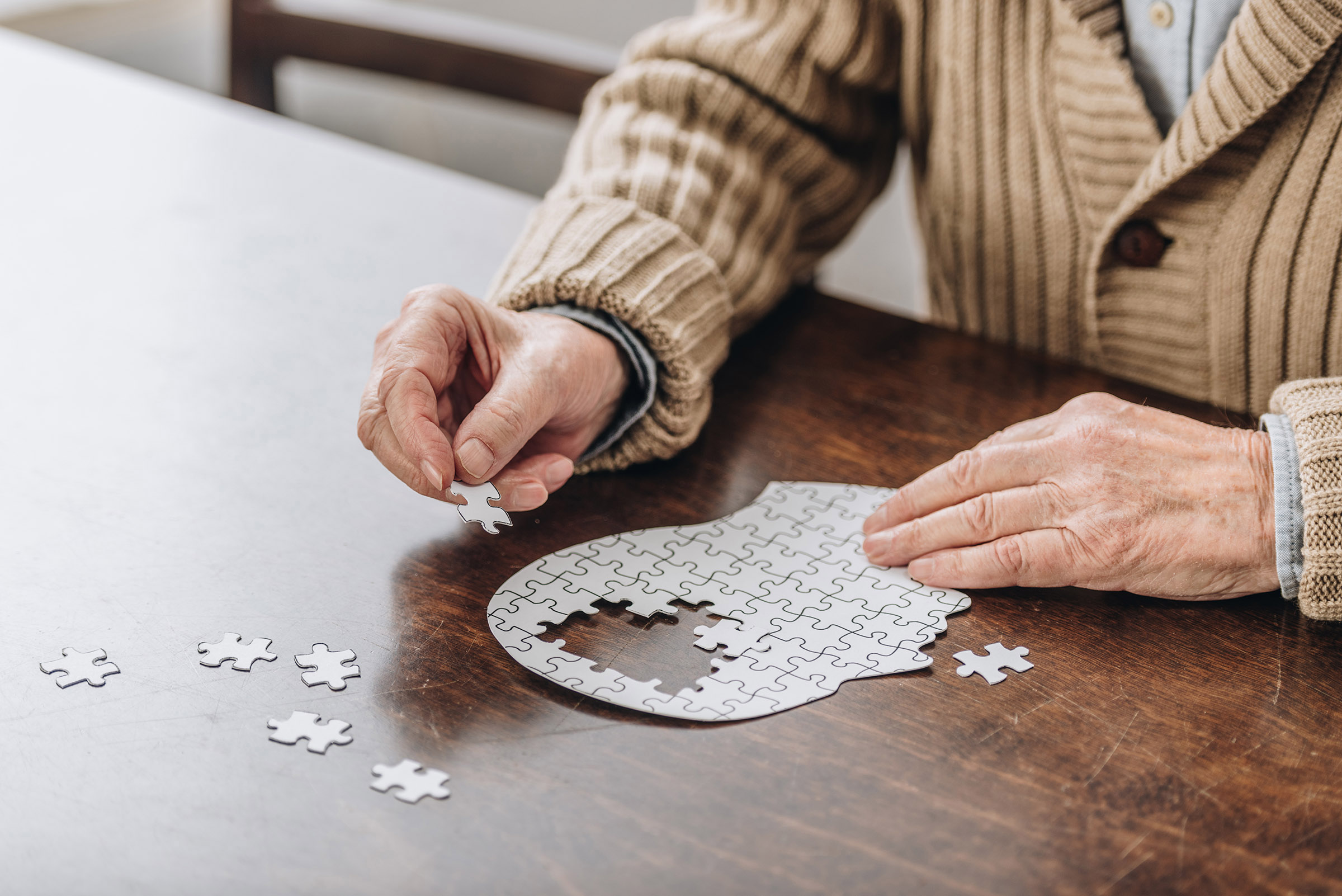 A senior playing with puzzles.