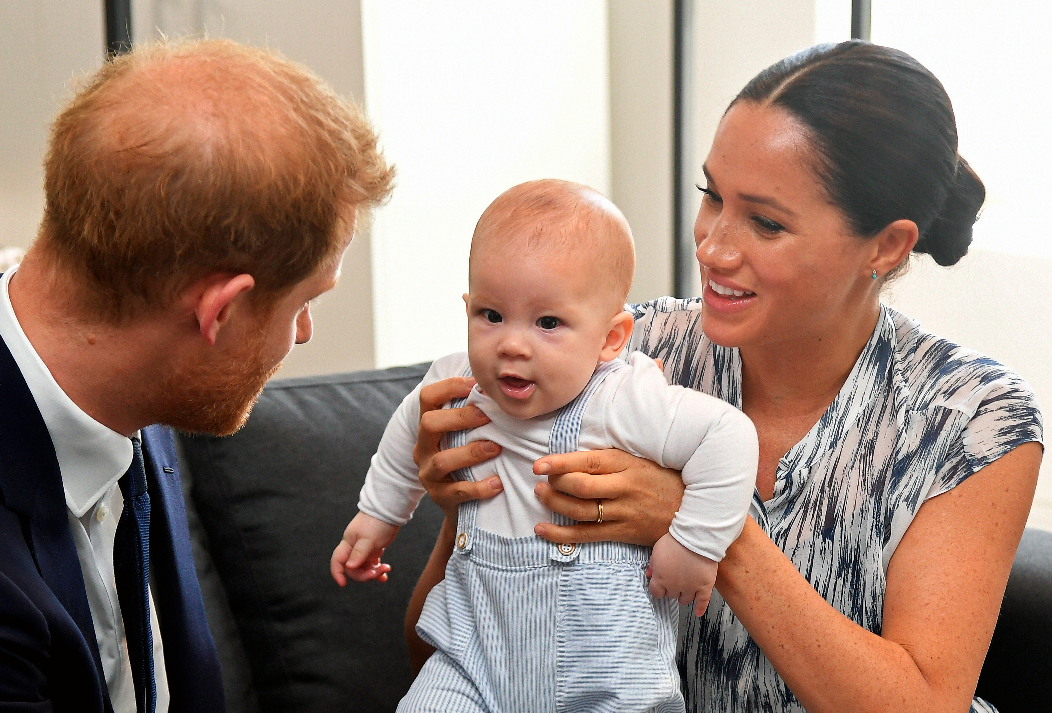Prince Harry, Duke of Sussex and Meghan, Duchess of Sussex tend to their baby son Archie Mountbatten-Windsor at a meeting with Archbishop Desmond Tutu on September 25, 2019 in Cape Town, South Africa. (Toby Melville—Getty Images)