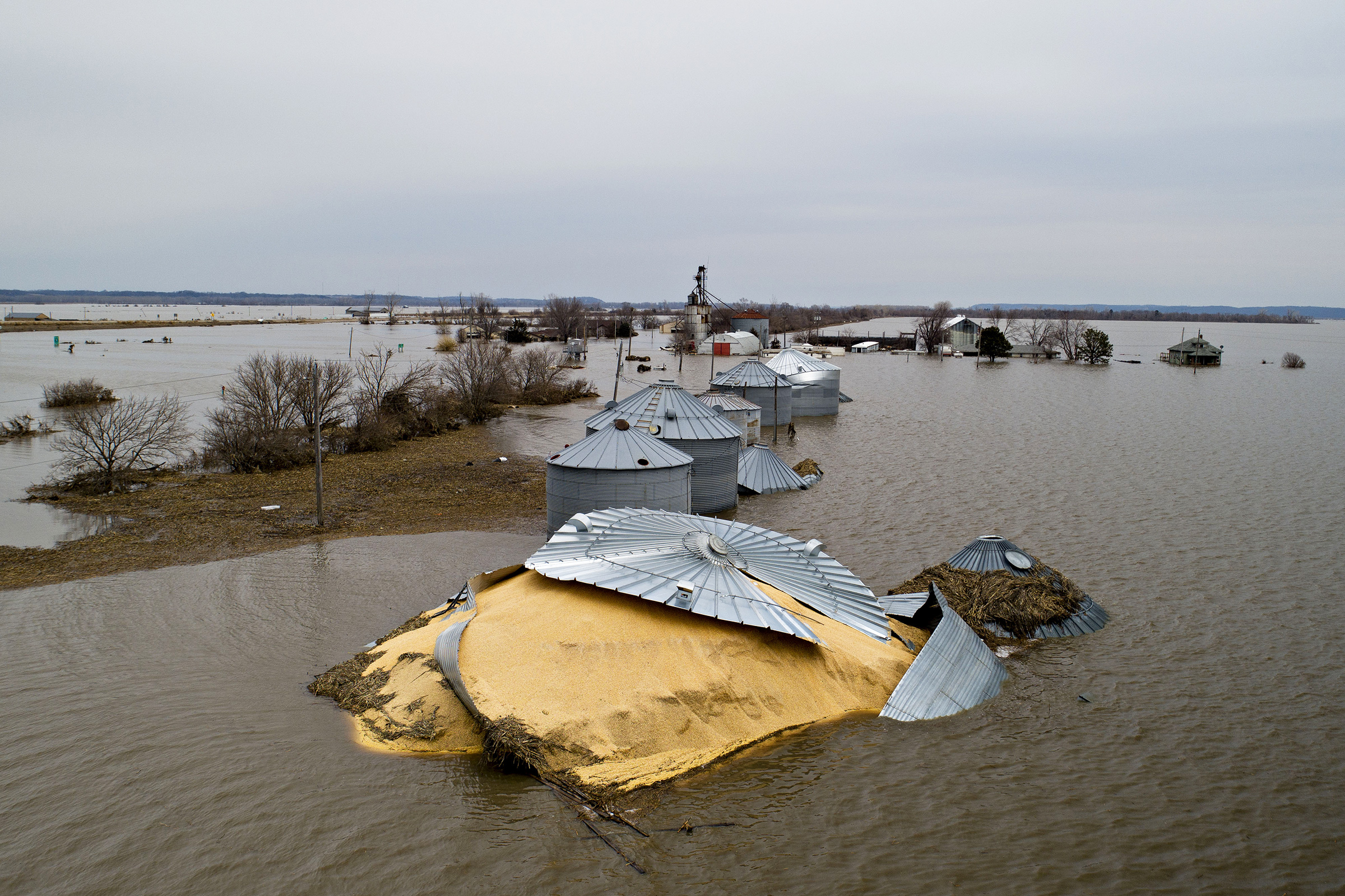 Floodwaters surround corn sitting under a collapsed grain bin in this aerial photograph over Thurman, Iowa, U.S., on Saturday, March 23, 2019. (Daniel Acker—Bloomberg/Getty Images)