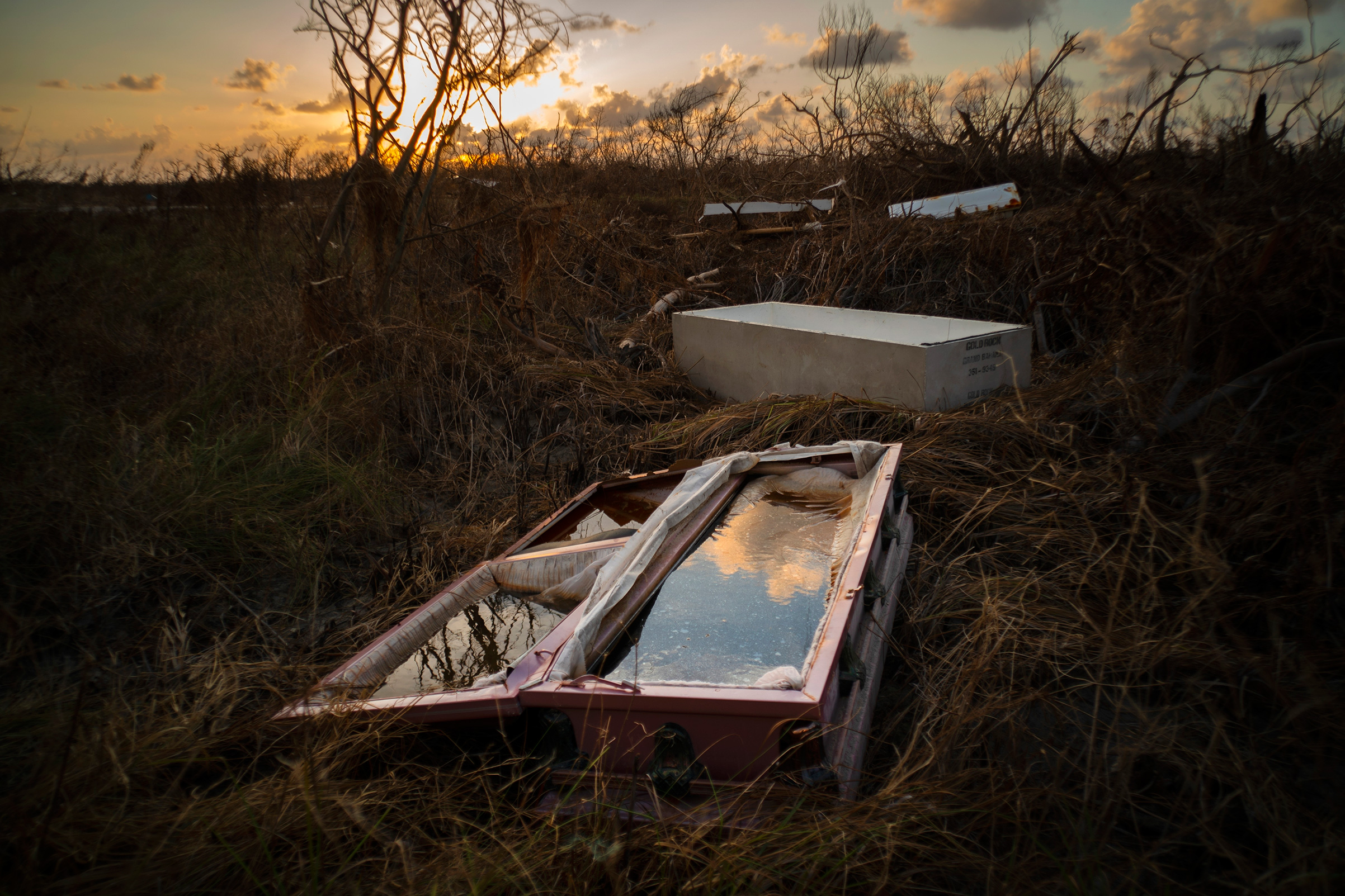 A water-filled coffin lays exposed to the elements in the aftermath of Hurricane Dorian, at the cemetery in Mclean's Town, Grand Bahama, Bahamas, Wednesday Sept. 11, 2019. (Ramon Espinosa—AP)