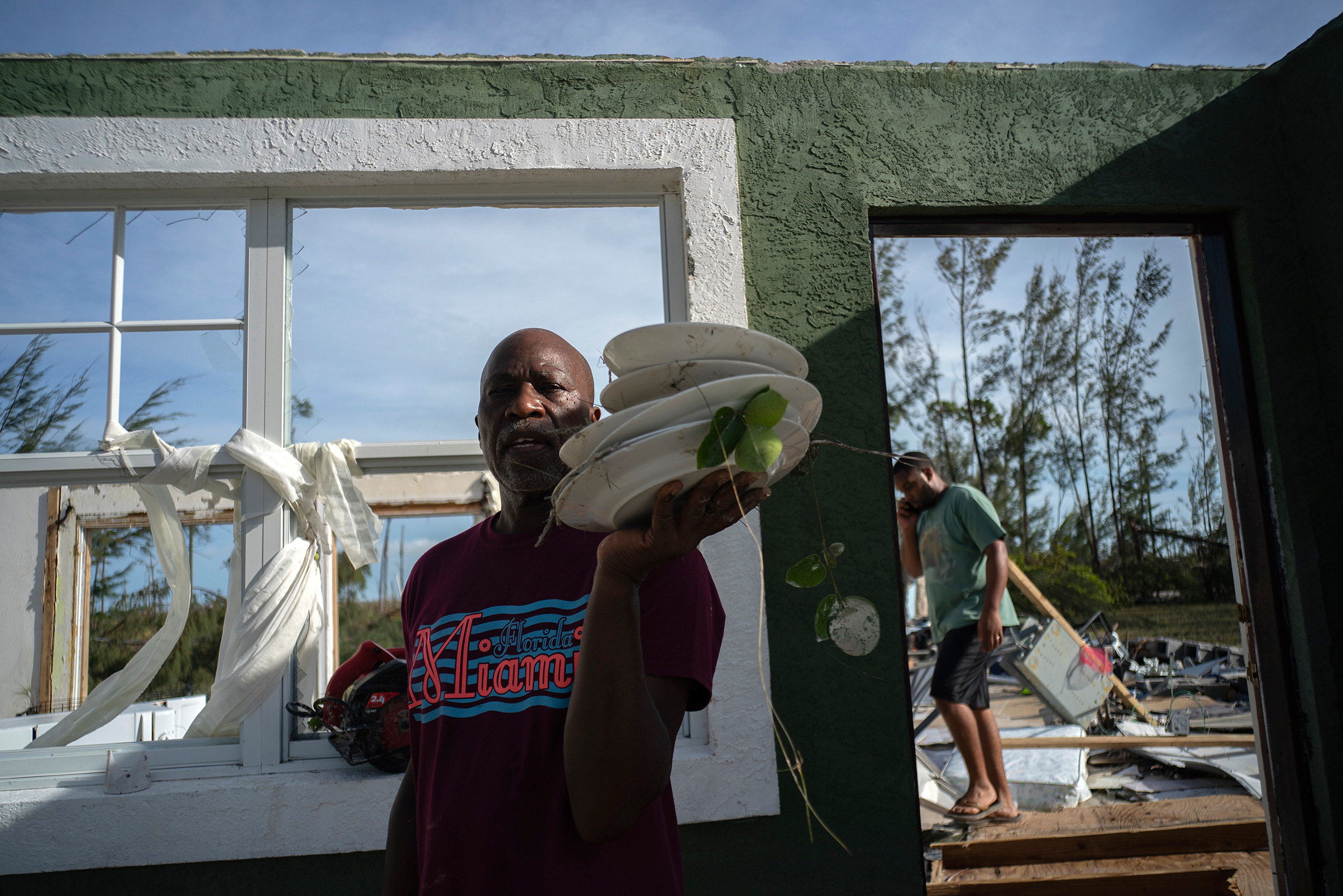 Mister Bolter recovers dishes from his son's home, destroyed by Hurricane Dorian in Pine Bay, near Freeport, Bahamas, Wednesday, Sept. 4, 2019. (Ramon Espinosa—AP)