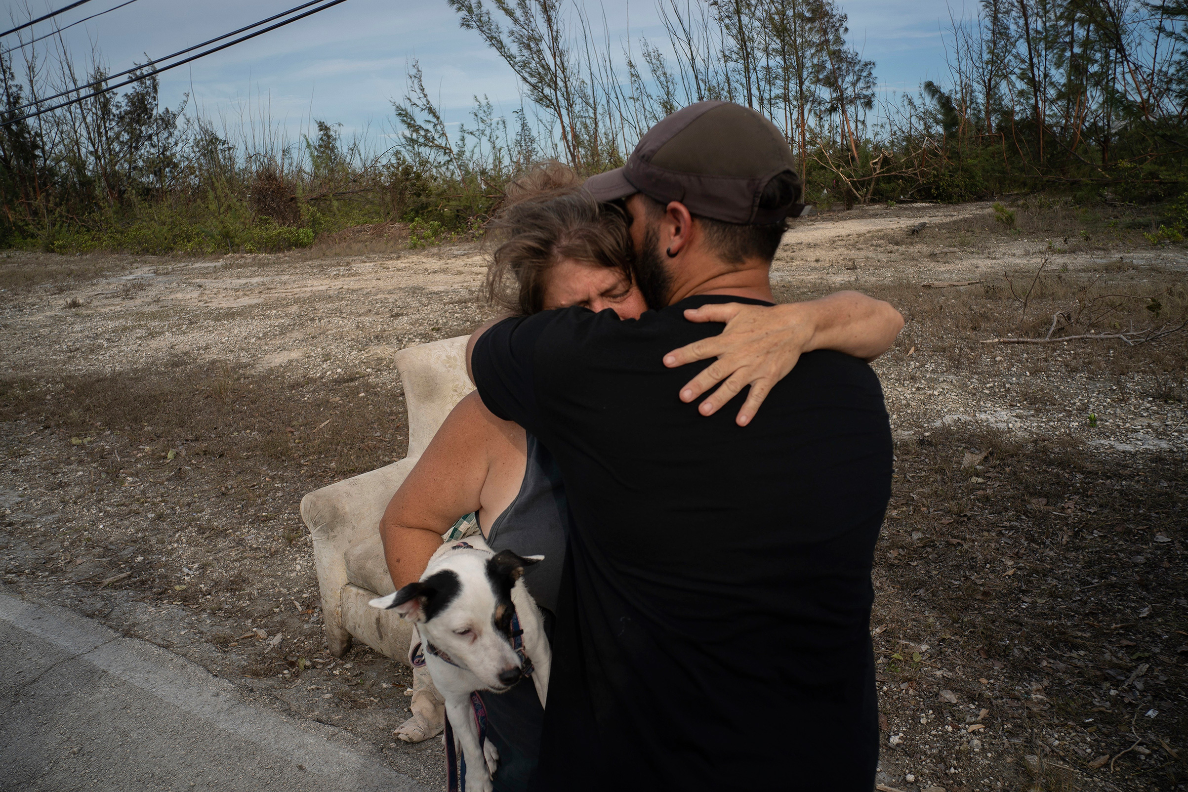 Sissel Mosvold embraces a volunteer who helped rescue her mother from her home when it was flooded by the waters of Hurricane Dorian, in the outskirts of Freeport, Bahamas, Sept. 4, 2019. (Ramon Espinosa—AP)