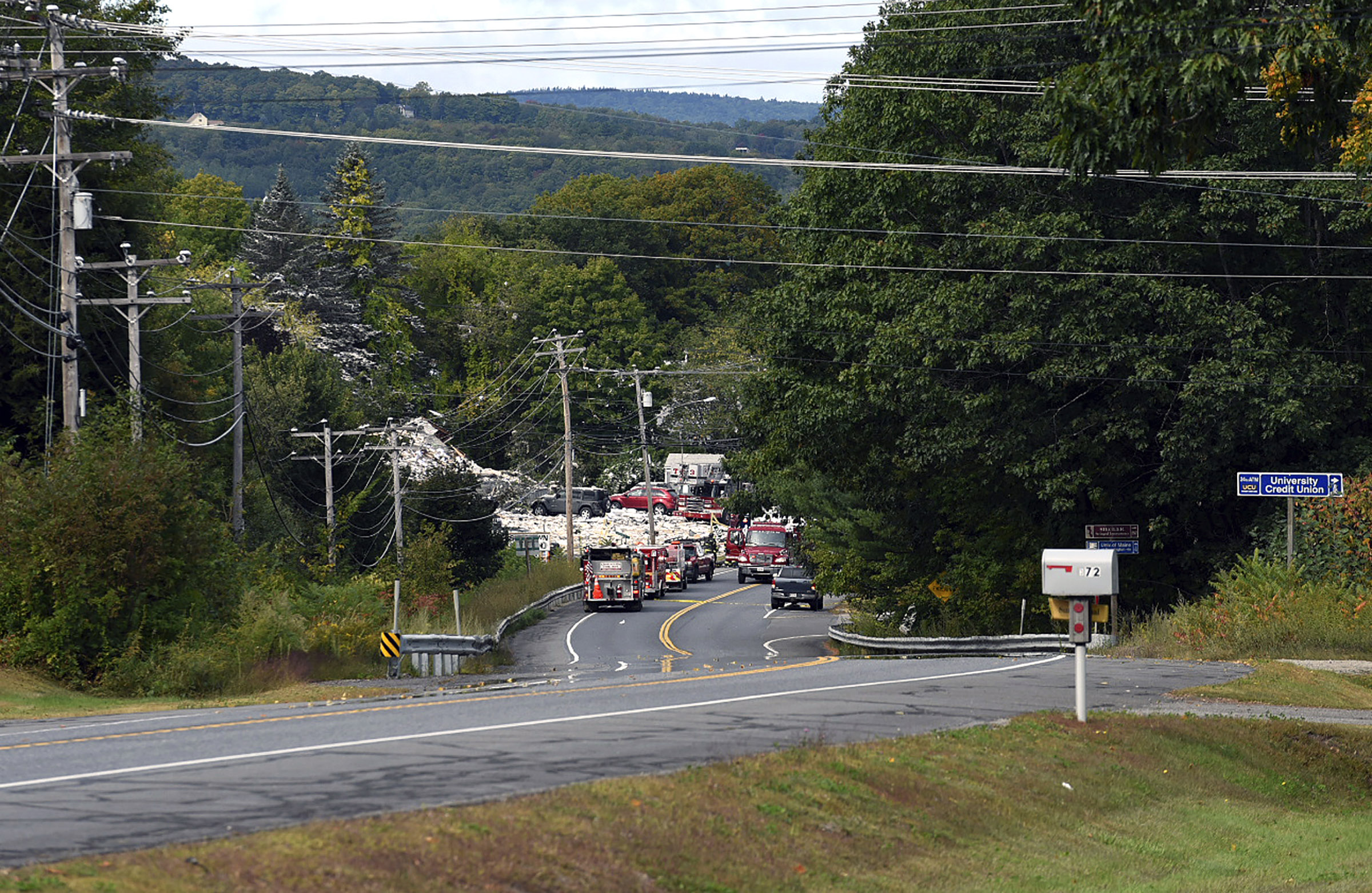 Emergency vehicles stand by on Sept. 16, 2019, at the scene of a deadly propane explosion which leveled new construction in Farmington, Maine. (Russ Dillingham—AP)