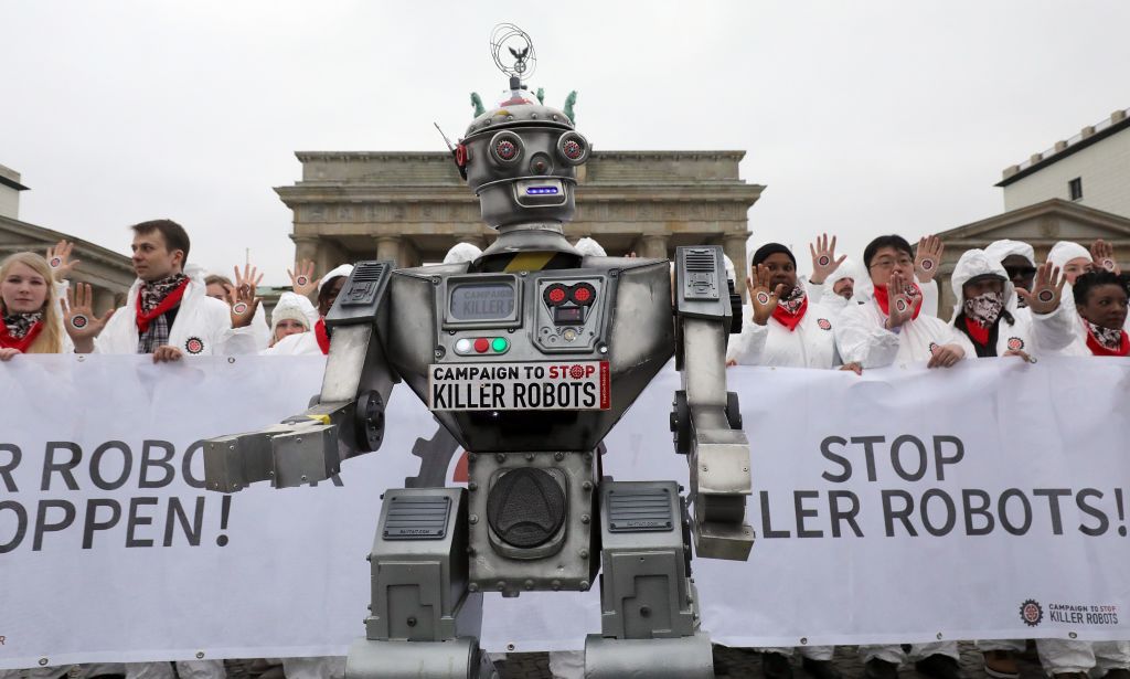 People take part in a demonstration as part of the campaign "Stop Killer Robots" organised by German NGO "Facing Finance" to ban what they call killer robots on March 21, 2019 in front of the Brandenburg Gate in Berlin. (WOLFGANG KUMM—AFP/Getty Images)