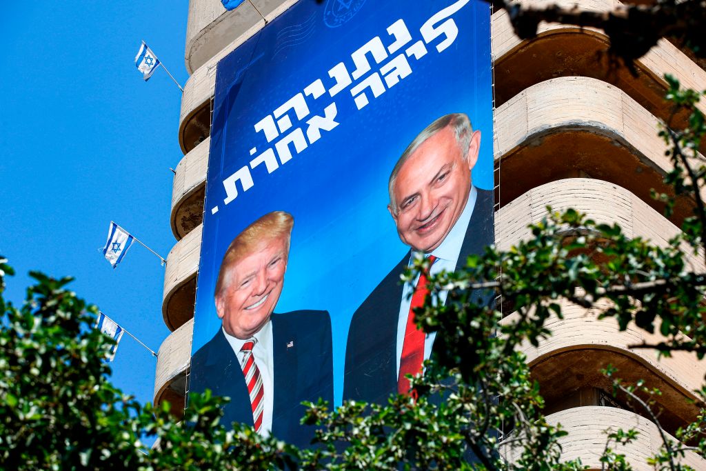 Two giant Israeli Likud Party election banners hanging from a Tel Aviv building show Israeli Prime Minister Benjamin Netanyahu shaking hands with U.S. President Donald Trump, with a caption above reading in Hebrew "Netanyahu, in another league" (JACK GUEZ&mdash;AFP/Getty Images)