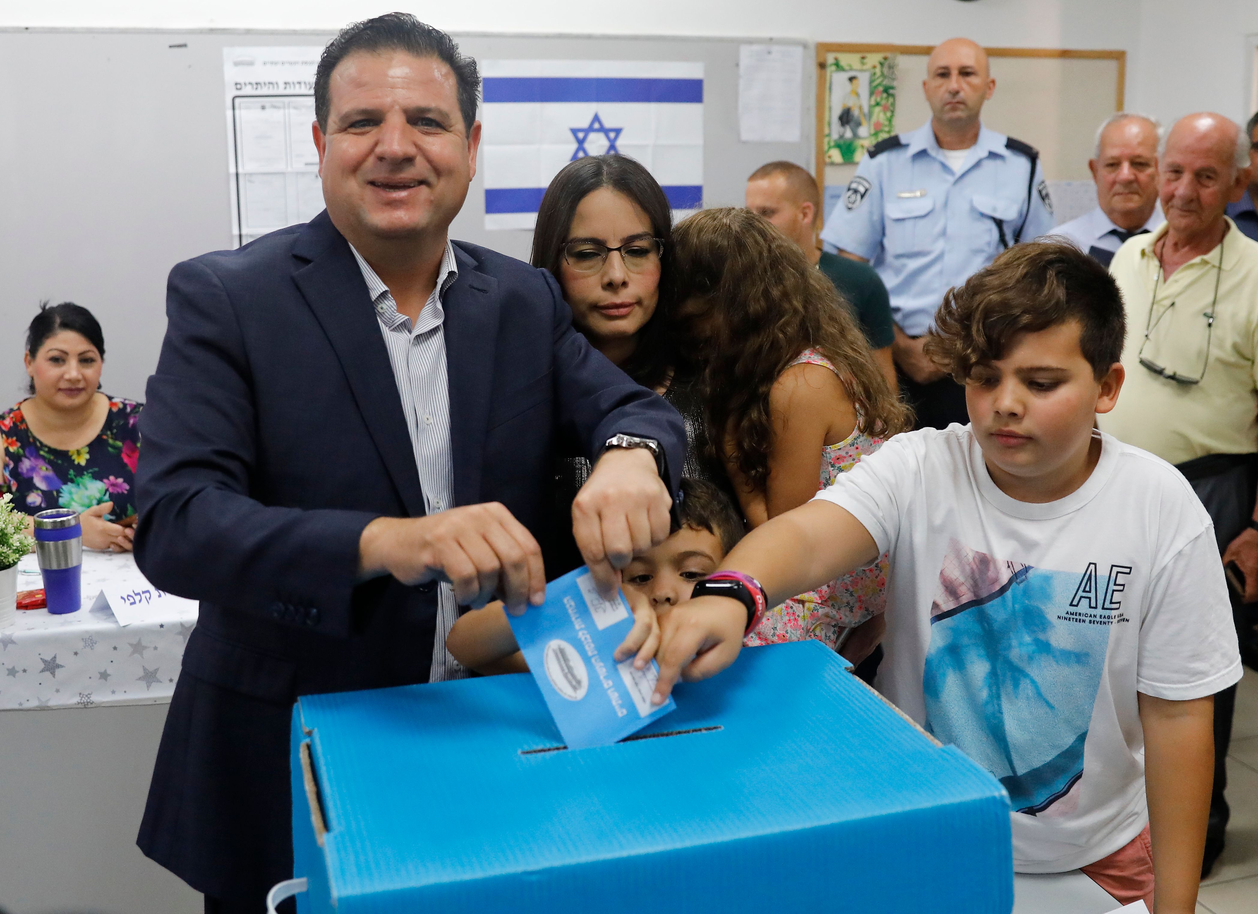 Israel's head of the mainly Arab Joint List alliance Ayman Odeh casts his ballot accompanied by his family during Israel's parliamentary election at a polling station in Haifa on September 17, 2019. (Ahmad Gharabli—AFP/Getty Images)