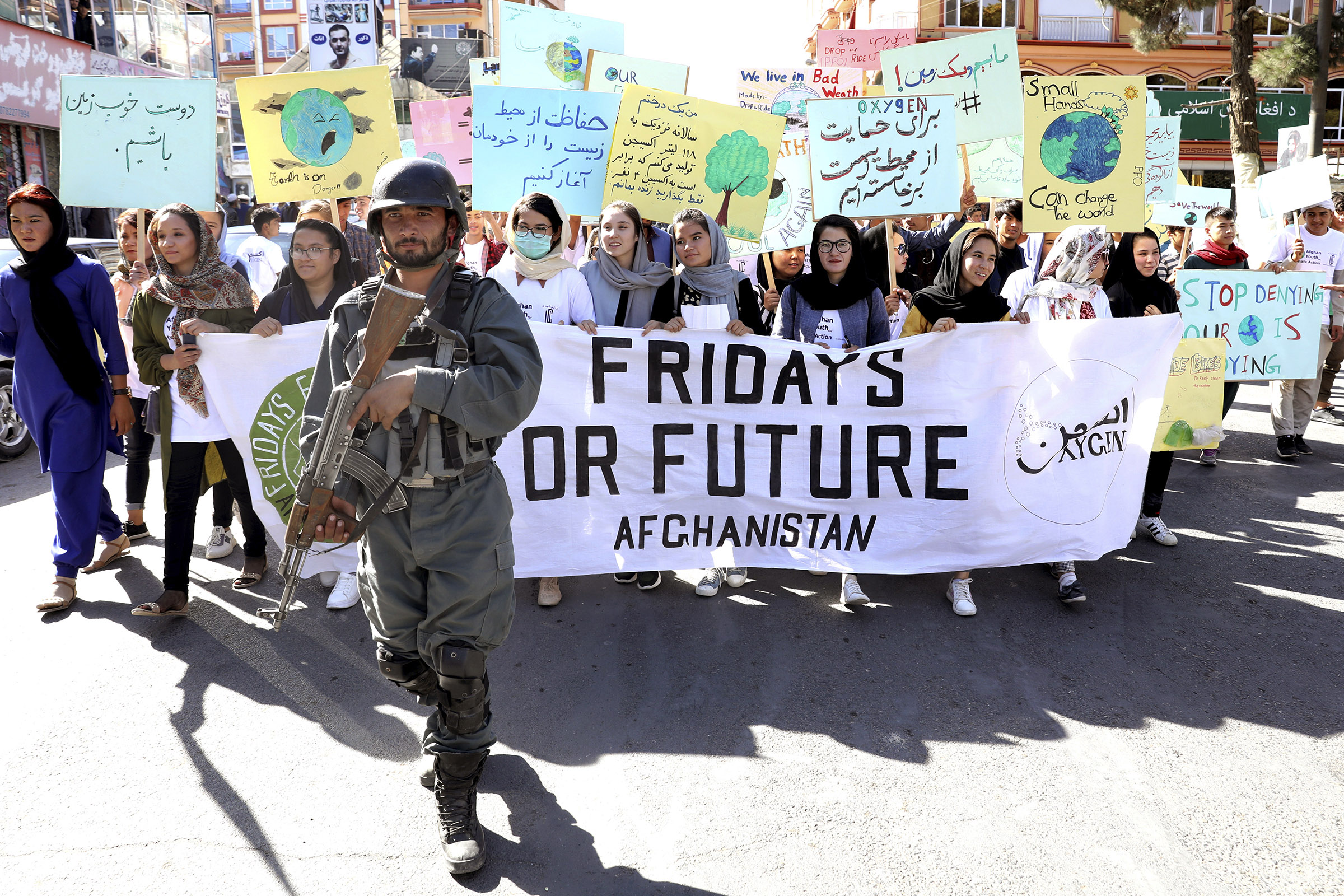 Young people attend a Climate Strike rally, as Afghan security forces guard them in Kabul, Afghanistan, Friday, Sept. 20, 2019. (Ebrahim Noroozi—AP)