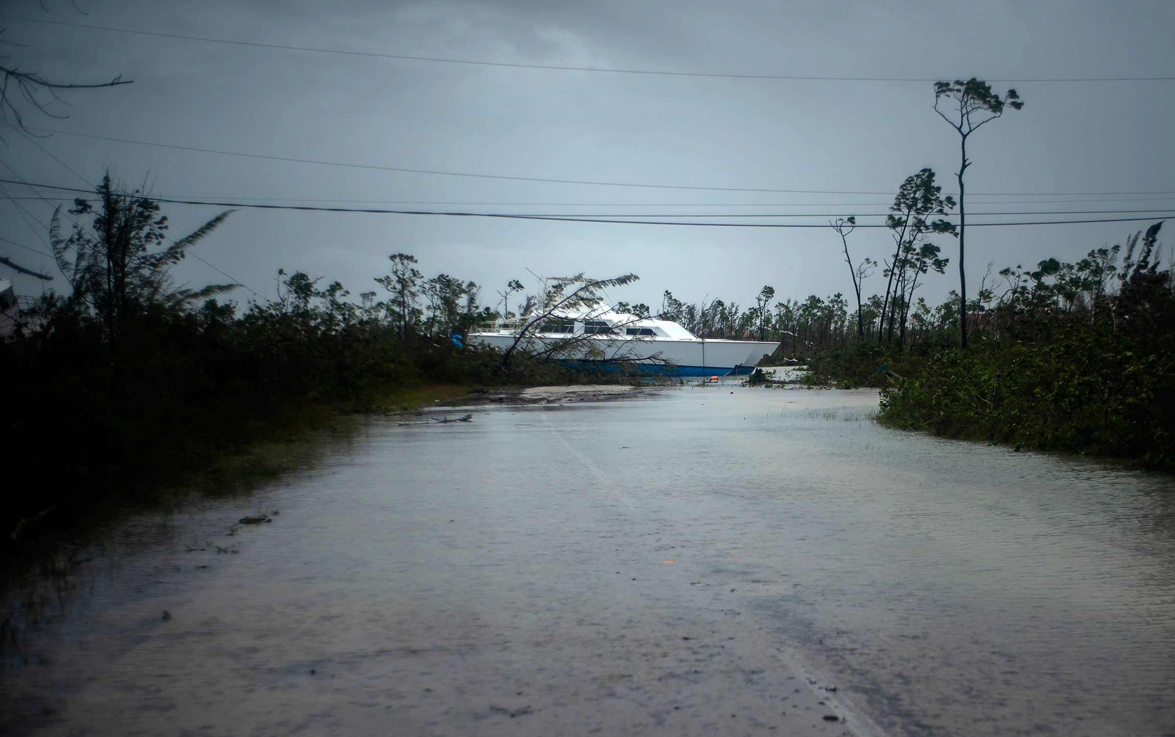 A catamaran thrown onshore by the hurricane lies stranded near a highway close to Freeport, Grand Bahama, Bahamas, on Sept. 3, 2019. (Ramon Espinosa—AP)