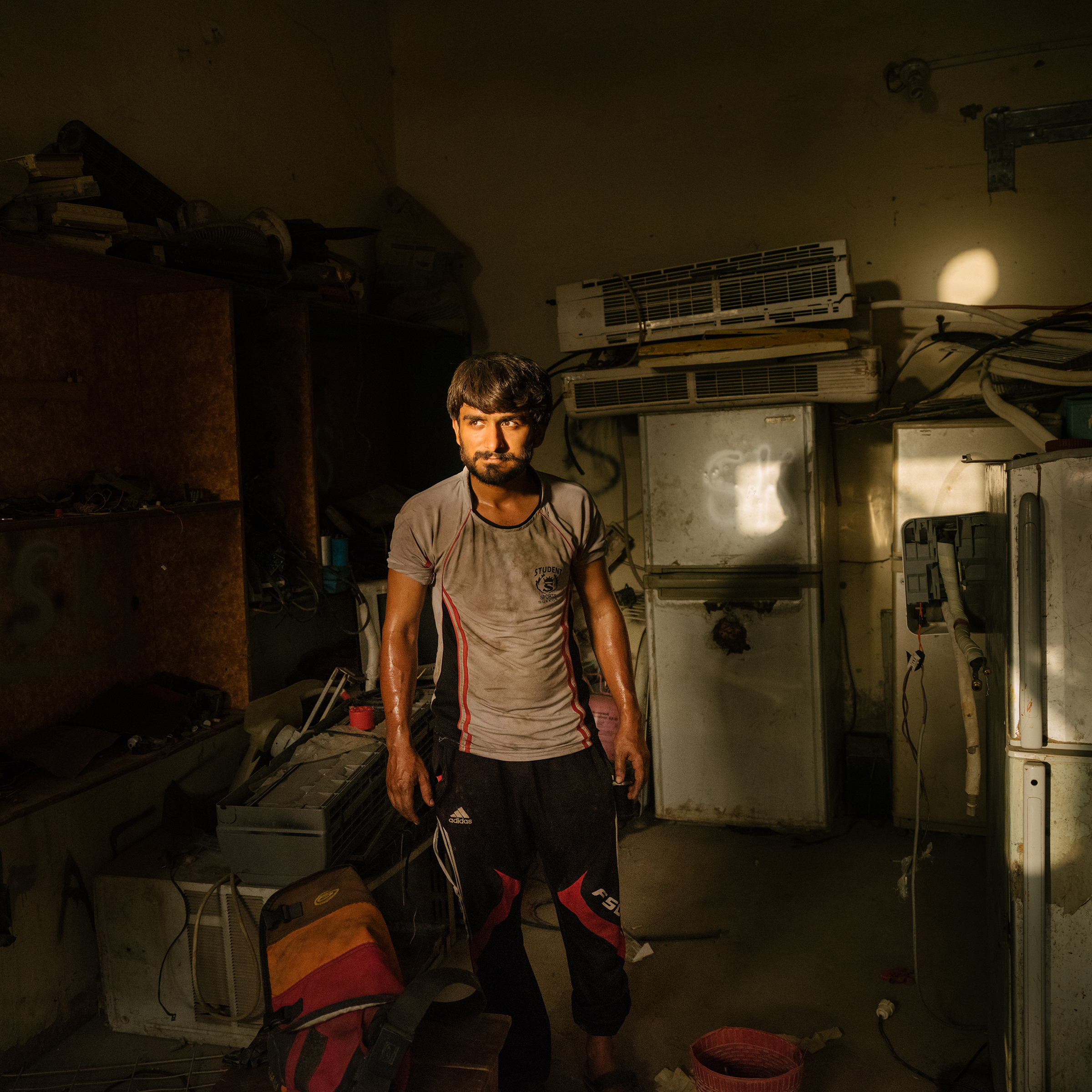 Khan Lala’s repair shop, seen on June 27, stays busy all summer; few air-conditioning units can handle the extreme heat. (Matthieu Paley for TIME)
