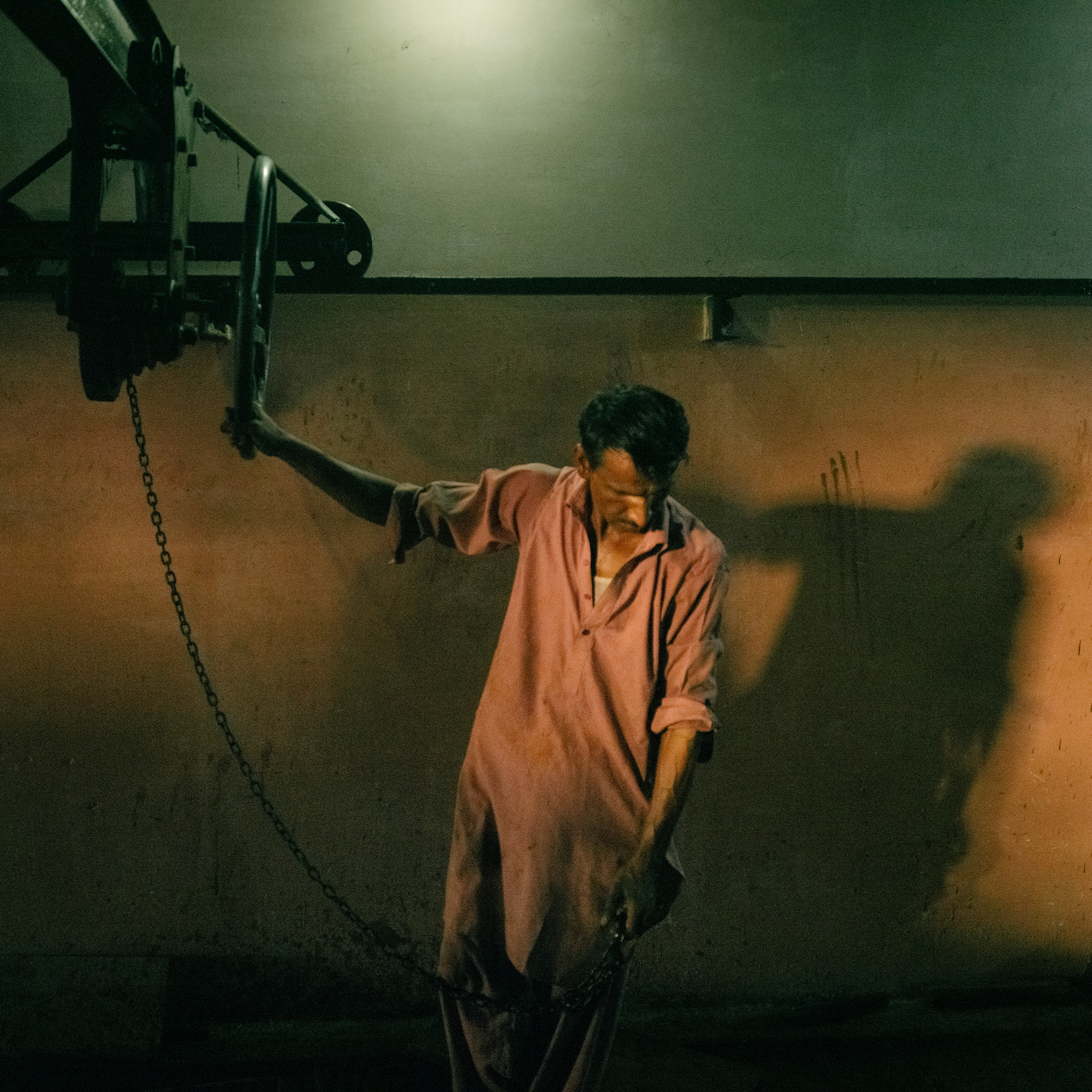 A worker moves an ice-lifting tool inside a factory on June 29.
