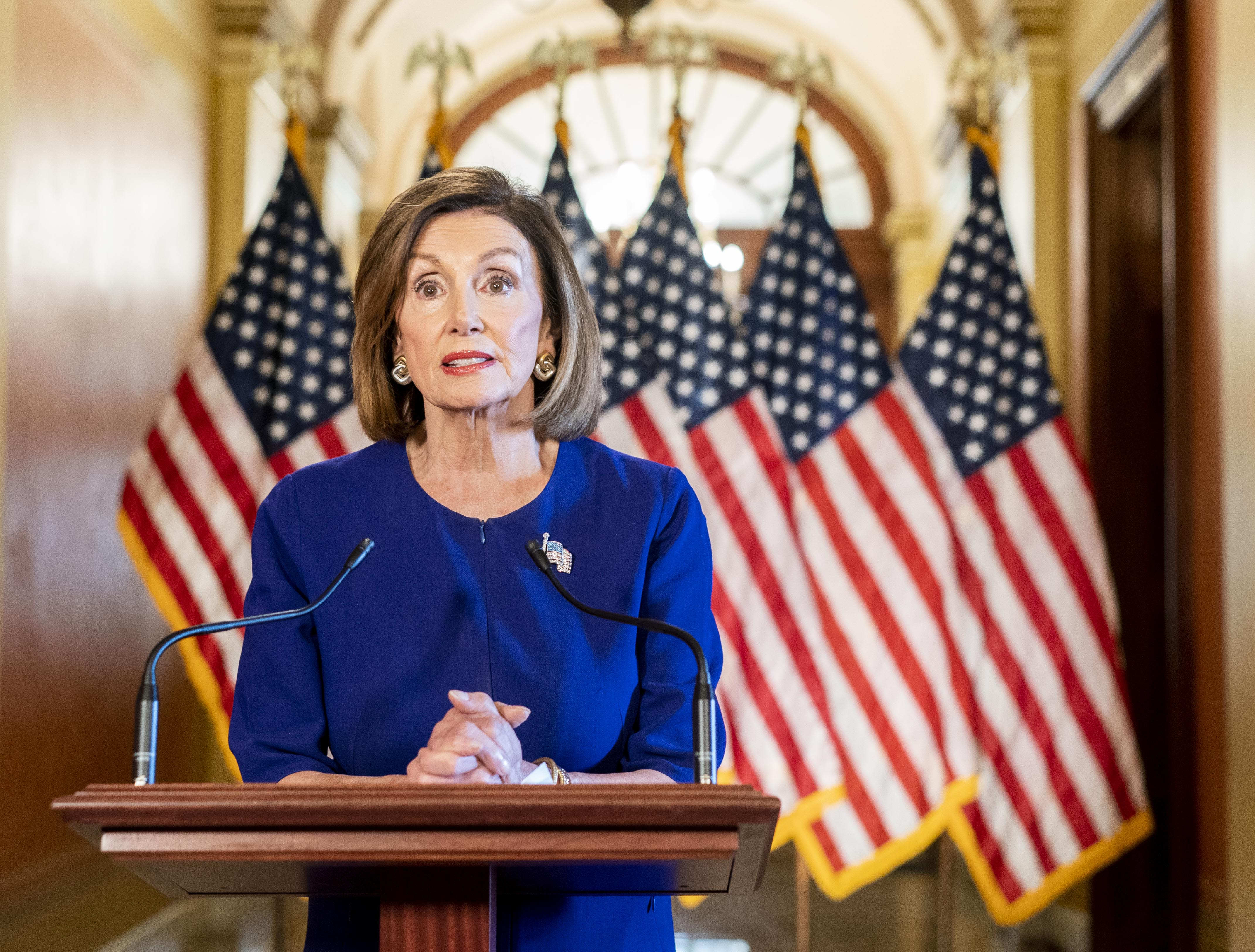 WASHINGTON, DC - September 24: From the Speaker's Balcony hallway, Speaker of the House Nancy Pelosi delivers a speech concerning a formal impeachment inquiry into President Donald Trump on Capitol Hill in Washington, DC on Tuesday September 24, 2019. (The Washington Post—The Washington Post/Getty Images)