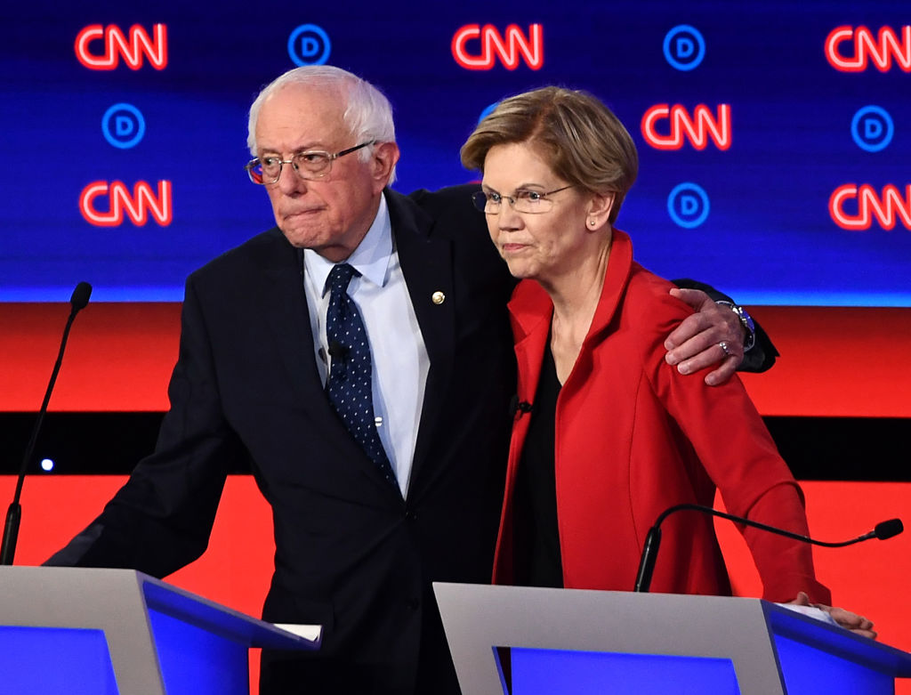 Vermont Sen. Bernie Sanders and Massachusetts Sen. Elizabeth Warren hug after participating in the first round of the second Democratic primary debate, on July 30, 2019. (BRENDAN SMIALOWSKI—AFP/Getty Images)