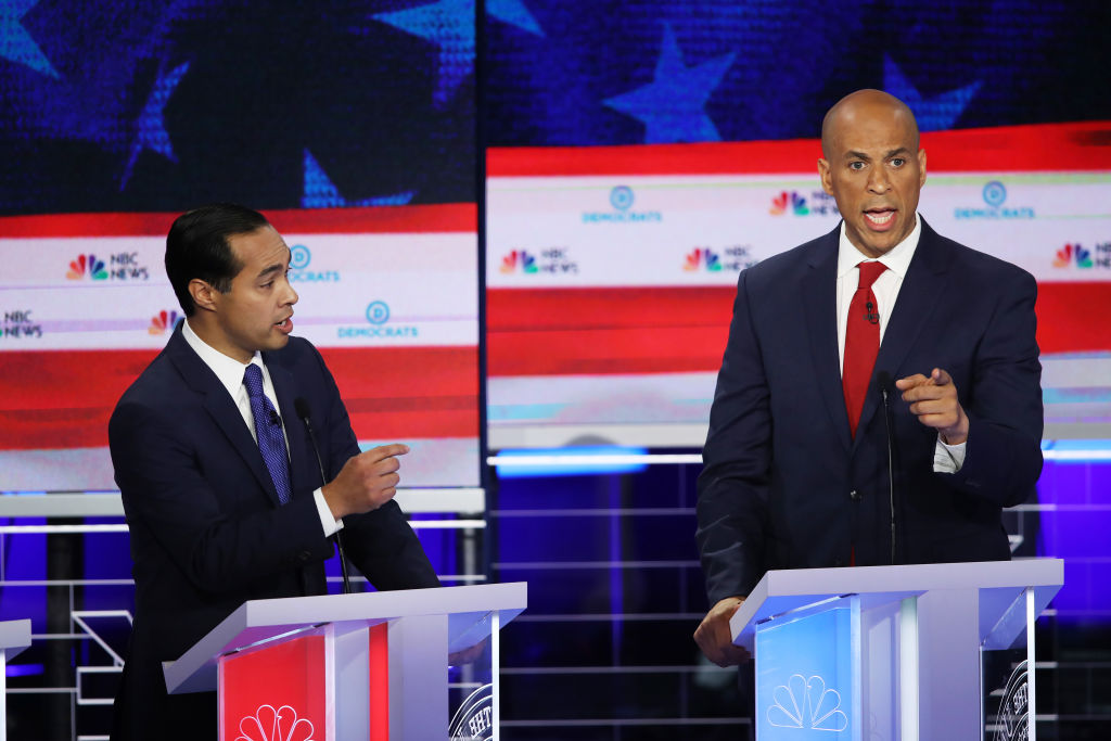 Former housing secretary Julian Castro and New Jersey Sen. Cory Booker during the first night of the Democratic presidential debate on June 26, 2019. (Joe Raedle—Getty Images)