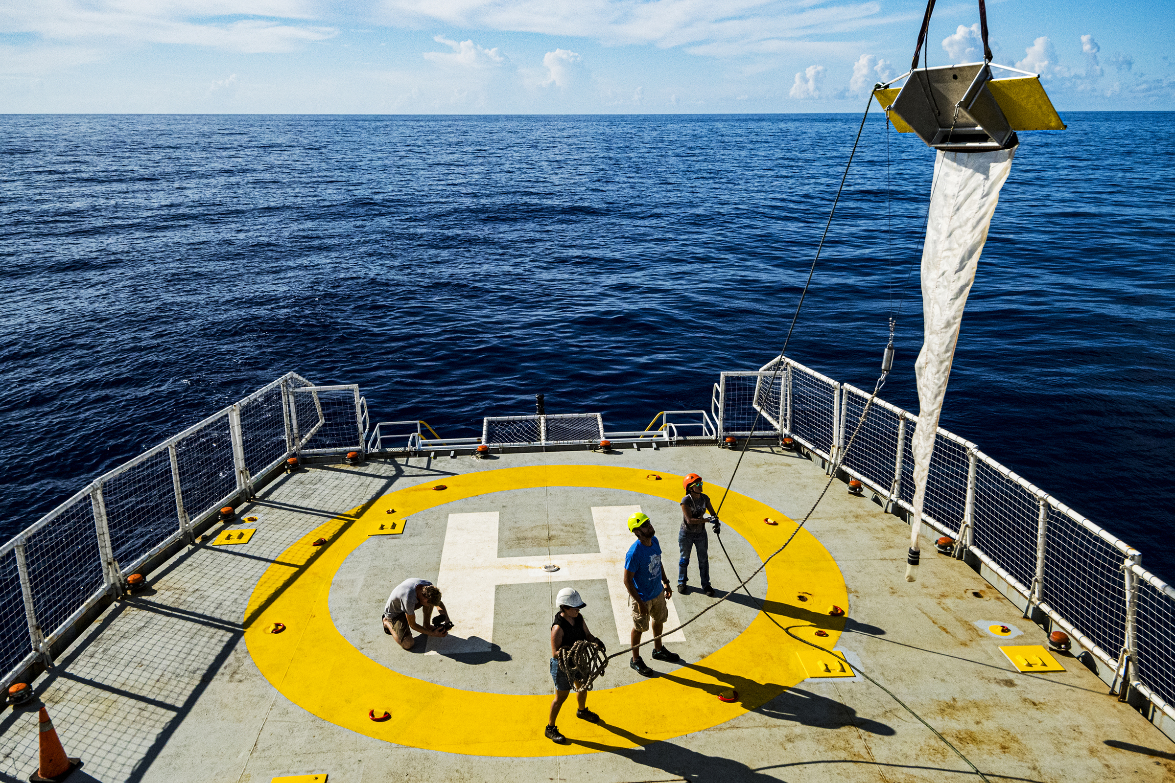 Crew members deploy a research trawl net from the deck of the MY Esperanza during the ship's expedition to the Sargasso Sea, a unique region in the North Atlantic Ocean that is home to a diverse array of marine life. (Shane Gross—Greenpeace.)