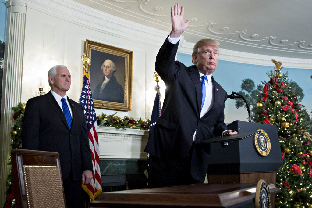 U.S. President Donald Trump waves next to U.S. Vice President Mike Pence, left, after making a statement on Jerusalem in the Diplomatic Room of the White House in Washington, D.C., U.S., on Wednesday, Dec. 6, 2017. (Andrew Harrer/Bloomberg via Getty Images)