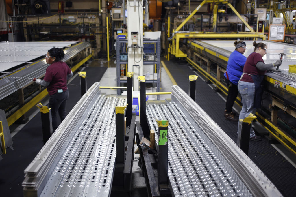 Aluminum semi-trailer components sit stacked at the Wabash National Corp. manufacturing facility in Lafayette, Indiana, U.S., on Tuesday, Aug. 13, 2019. American manufacturing unexpectedly contracted in August. (Luke Sharrett—Bloomberg/Getty Images)