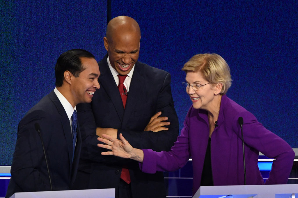 Former US Secretary of Housing and Urban Development Julian Castro, US Senator from New Jersey Cory Booker and US Senator from Massachusetts Elizabeth Warren laugh during a break in the first Democratic primary debate of the 2020 presidential campaign season in Miami, Florida, June 26, 2019. (JIM WATSON--AFP/Getty Images)