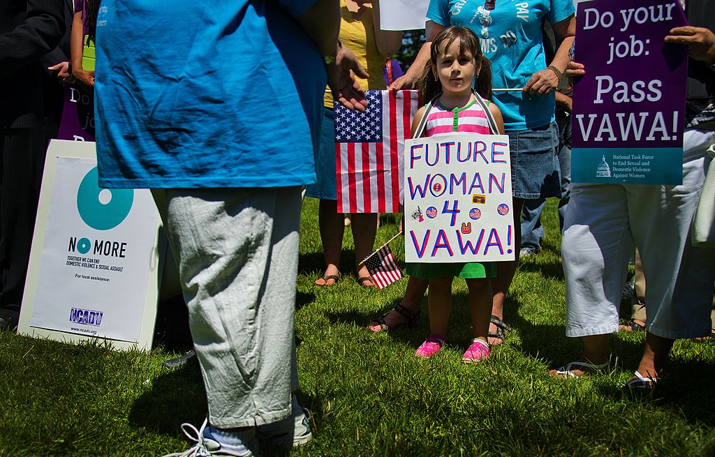 A young girl stands with supporters of the National Organization for Women (NOW) and the National Task Force to End Sexual Assault and Domestic Violence Against Women as they hold a rally for the reauthorization of the Violence Against Women Act (VAWA) outside the U.S. Capitol in Washington, D.C., on June 26, 2012. (JIM WATSON&mdash;AFP/Getty Images)
