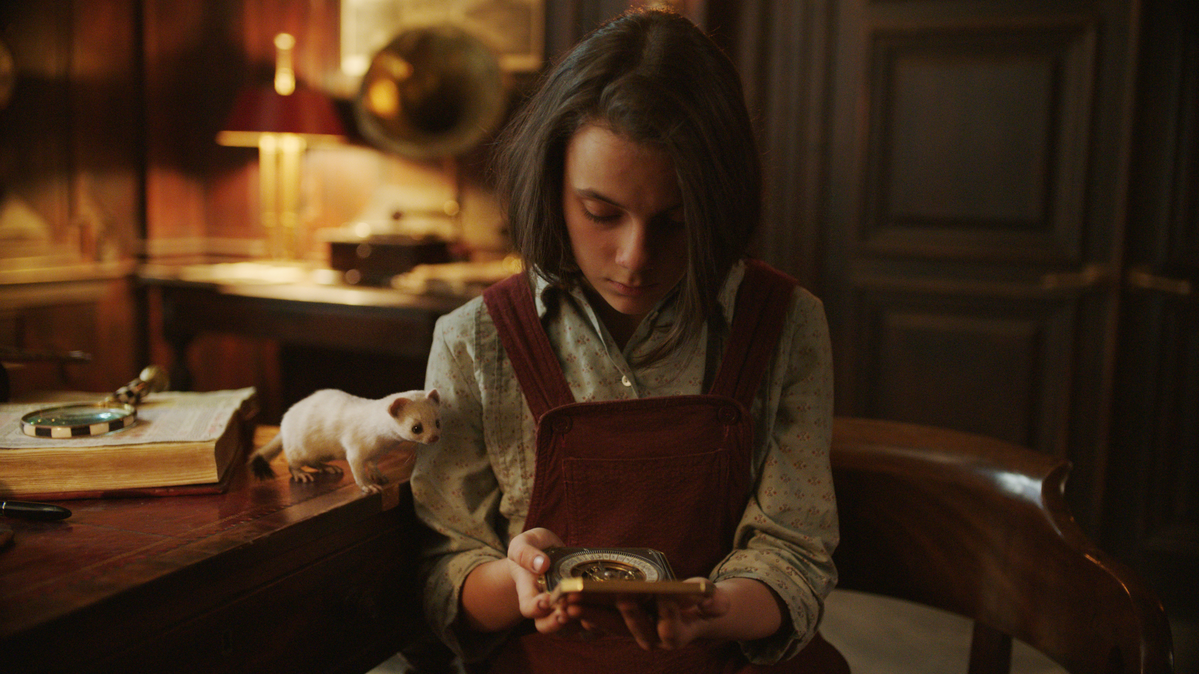Lyra (Dafne Keen) and her alethiometer in 'His Dark Materials' (HBO)