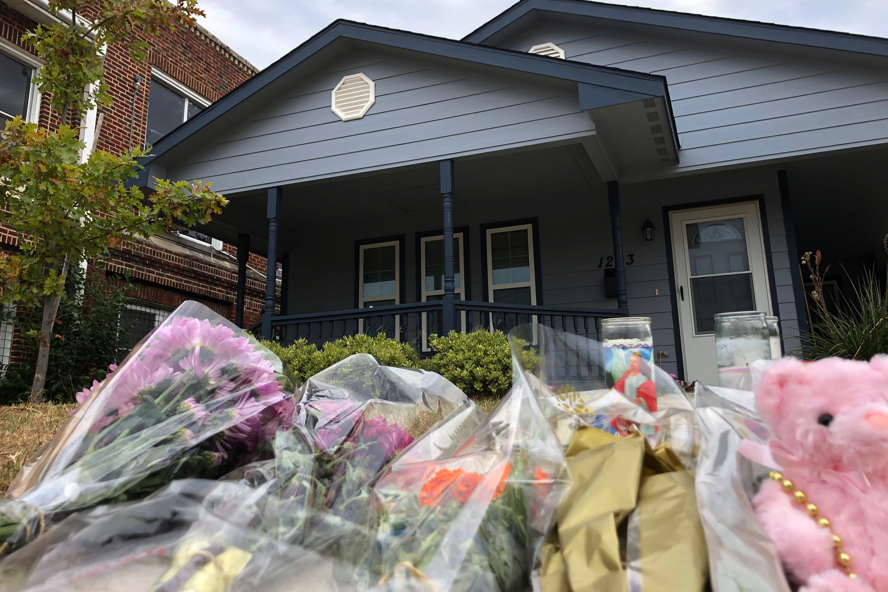 Bouquets of flowers and stuffed animals are piling up outside the Fort Worth home Monday, Oct. 14, 2019, where a 28-year-old black woman was shot to death by a white police officer. Members of the community have brought tributes to the home where Atatiana Jefferson was killed early Saturday by an officer who was responding to a neighbor's report of an open door. (Jake Bleiberg—AP)