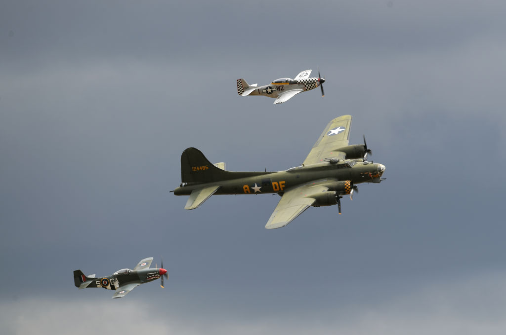 The U.K.'s last airworthy B-17 Flying Fortress, 'Sally B,' is flanked by a pair of P-51 Mustangs during the Flying Legends Air Show at IWM Duxford. (Joe Giddens - PA Images via Getty Images)