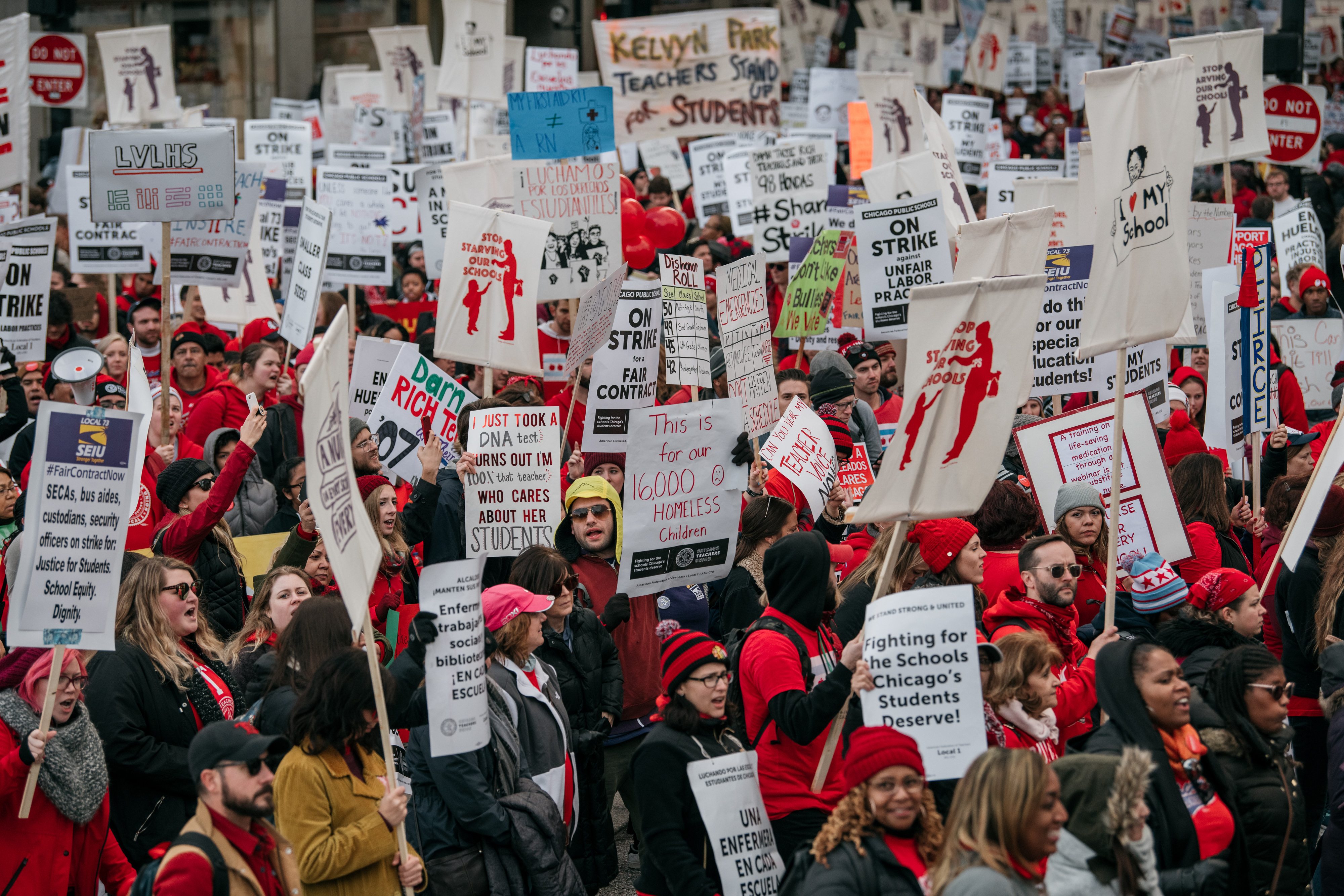 Demonstrators carry signs while marching during a teachers strike in downtown Chicago, Illinois, U.S., on Oct. 17, 2019. (Scott Heins—Bloomberg/Getty Images)