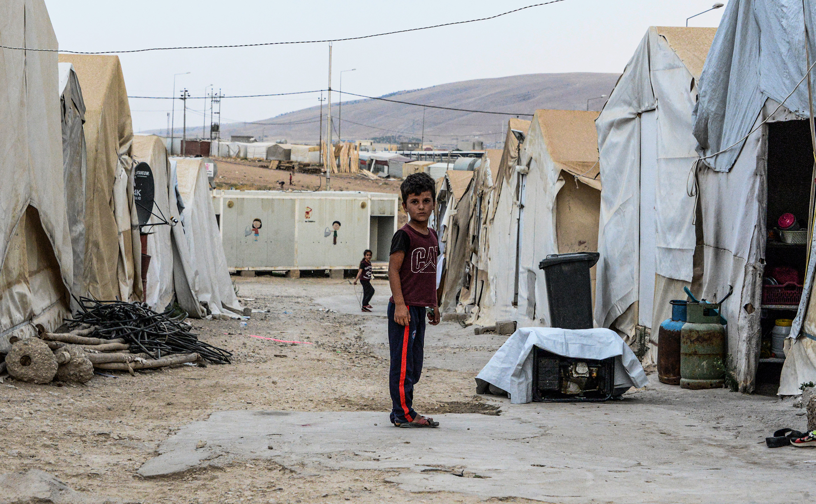 A boy stands between tents at a camp for internally displaced persons (IDP) of Iraq's Yazidi minority in the Sharya area, some 15 kilometres from the northern city of Dohuk in the autonomous Iraqi Kurdistan region on August 30, 2019. (Zaid Al-Obeidi—AFP/Getty Images)