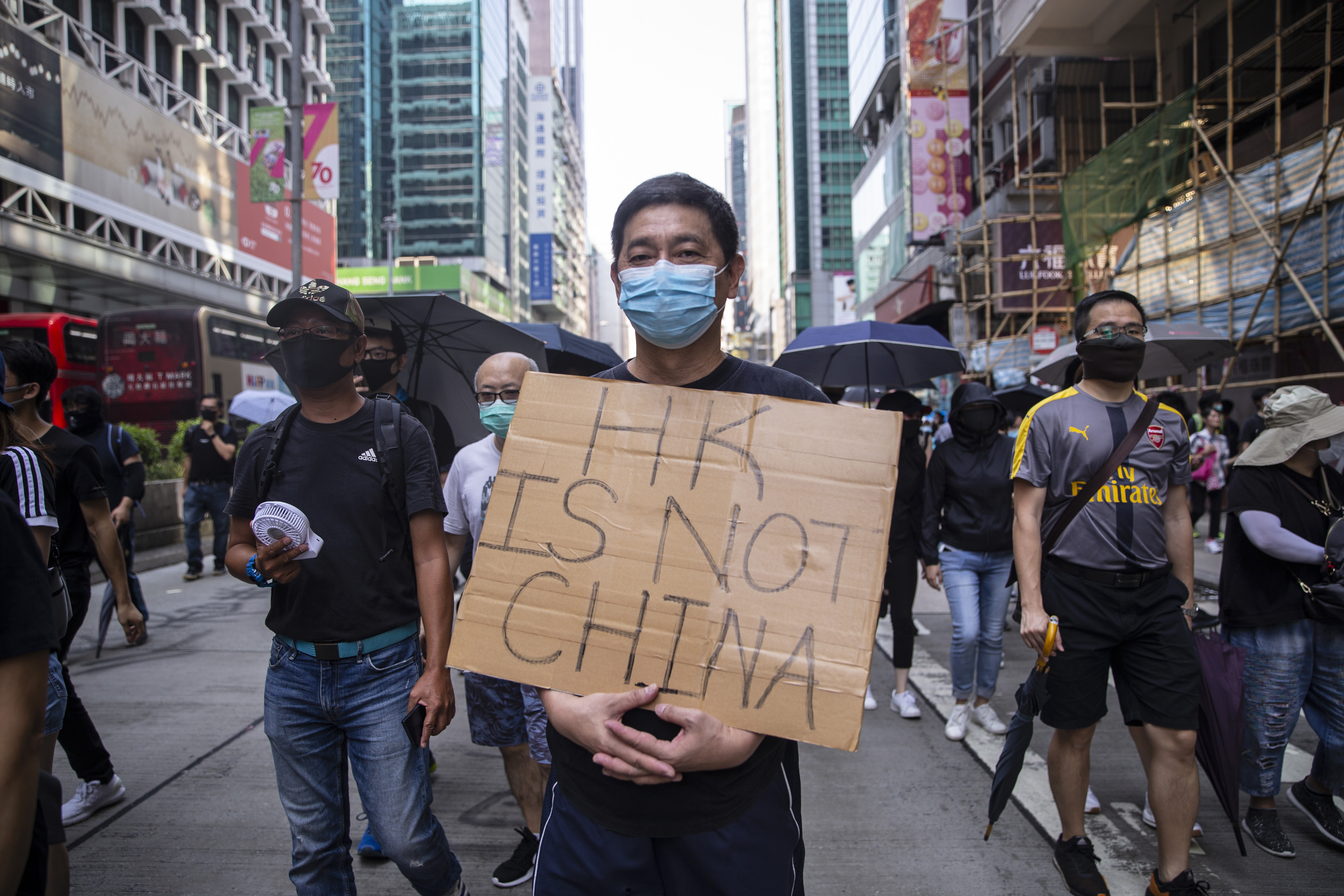 A pro-democracy demonstrator holds a sign reading "HK Is Not China" during a protest in the Mong Kok district of Hong Kong, China, on Tuesday, Oct. 1, 2019. (Chan Long Hei/Bloomberg via Getty Images)